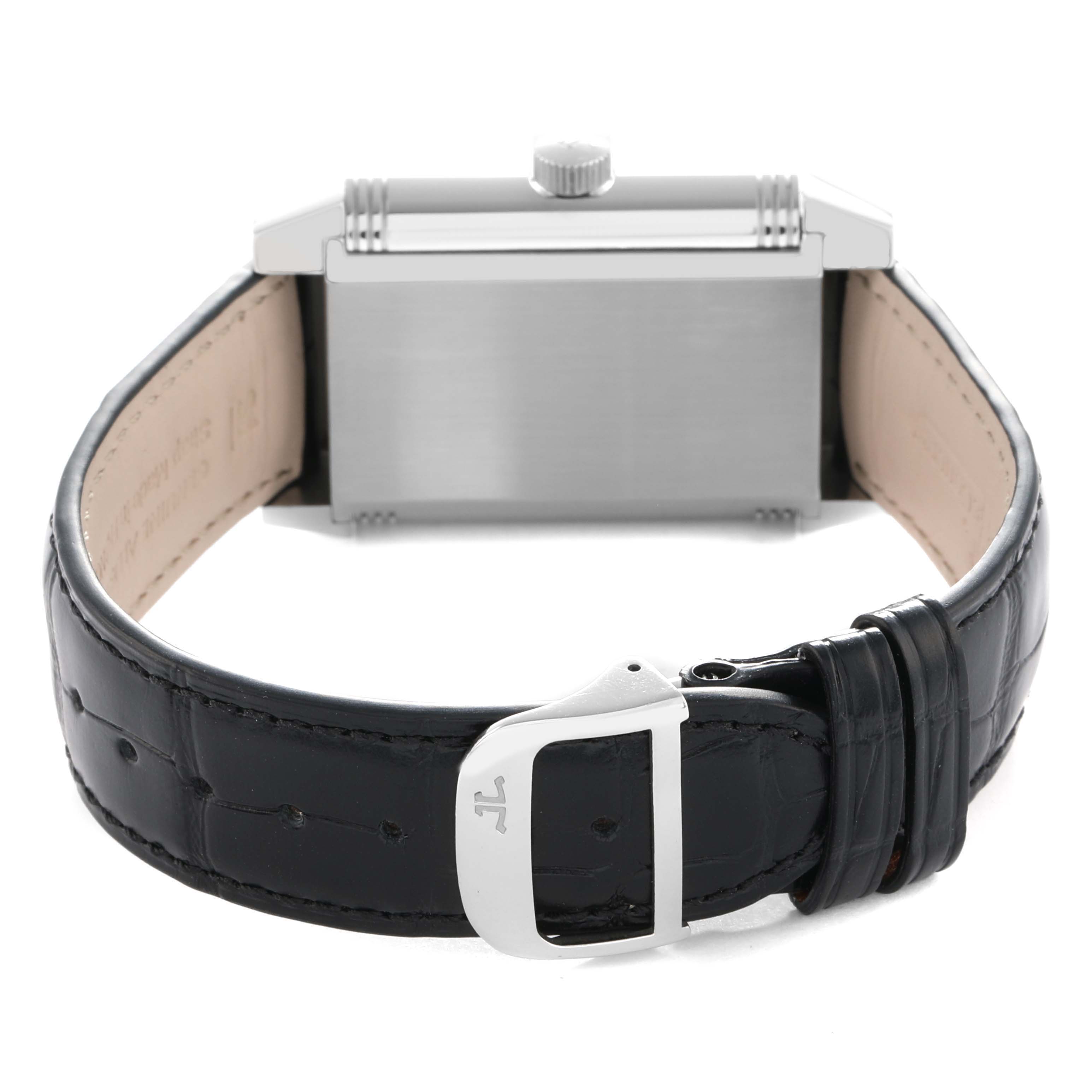 The image shows the Jaeger-LeCoultre Reverso watch from a rear angle, highlighting the back case, crown, and leather strap with buckle.