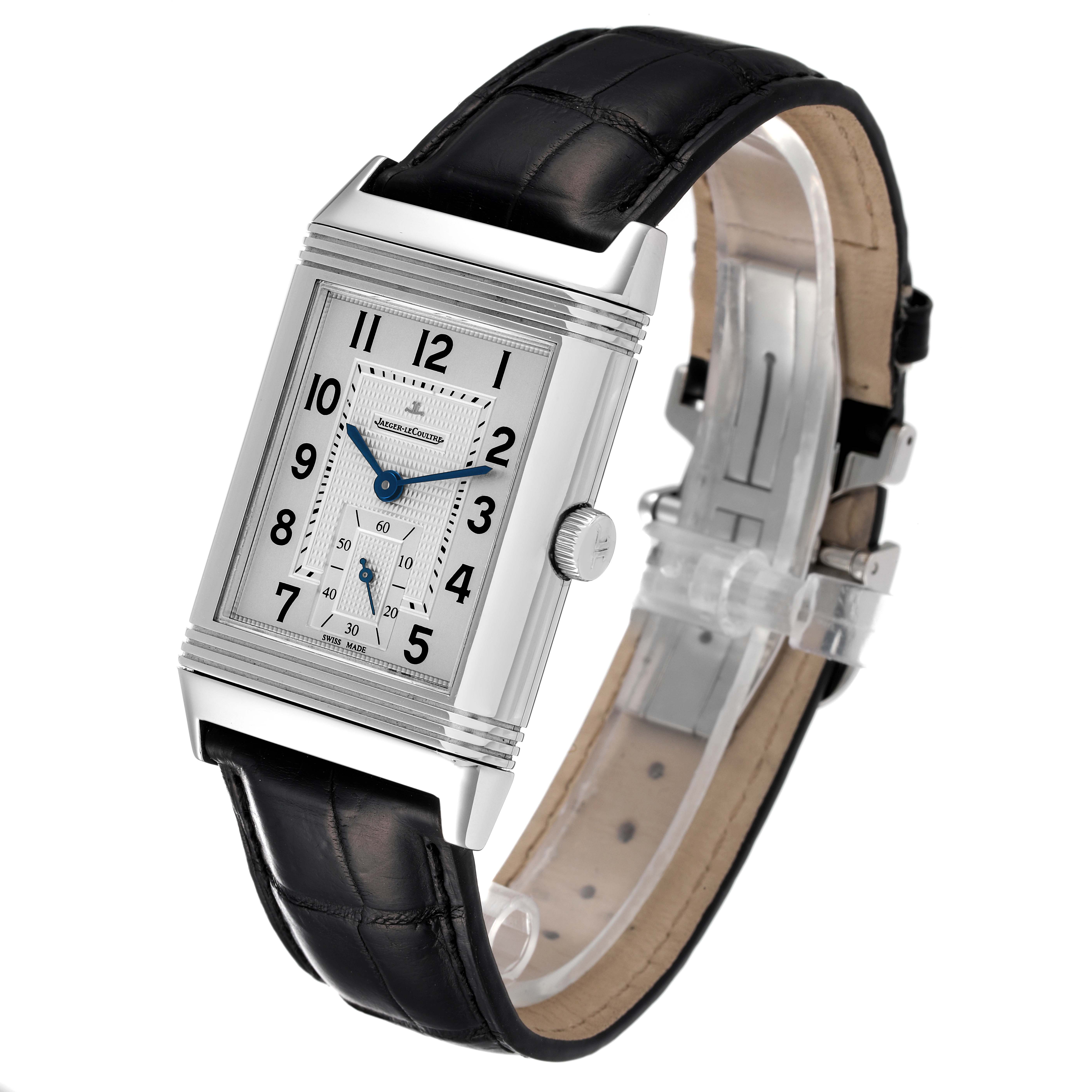 The image shows a Jaeger-LeCoultre Reverso watch at a slight angle, highlighting its rectangular face, black leather strap, and crown.