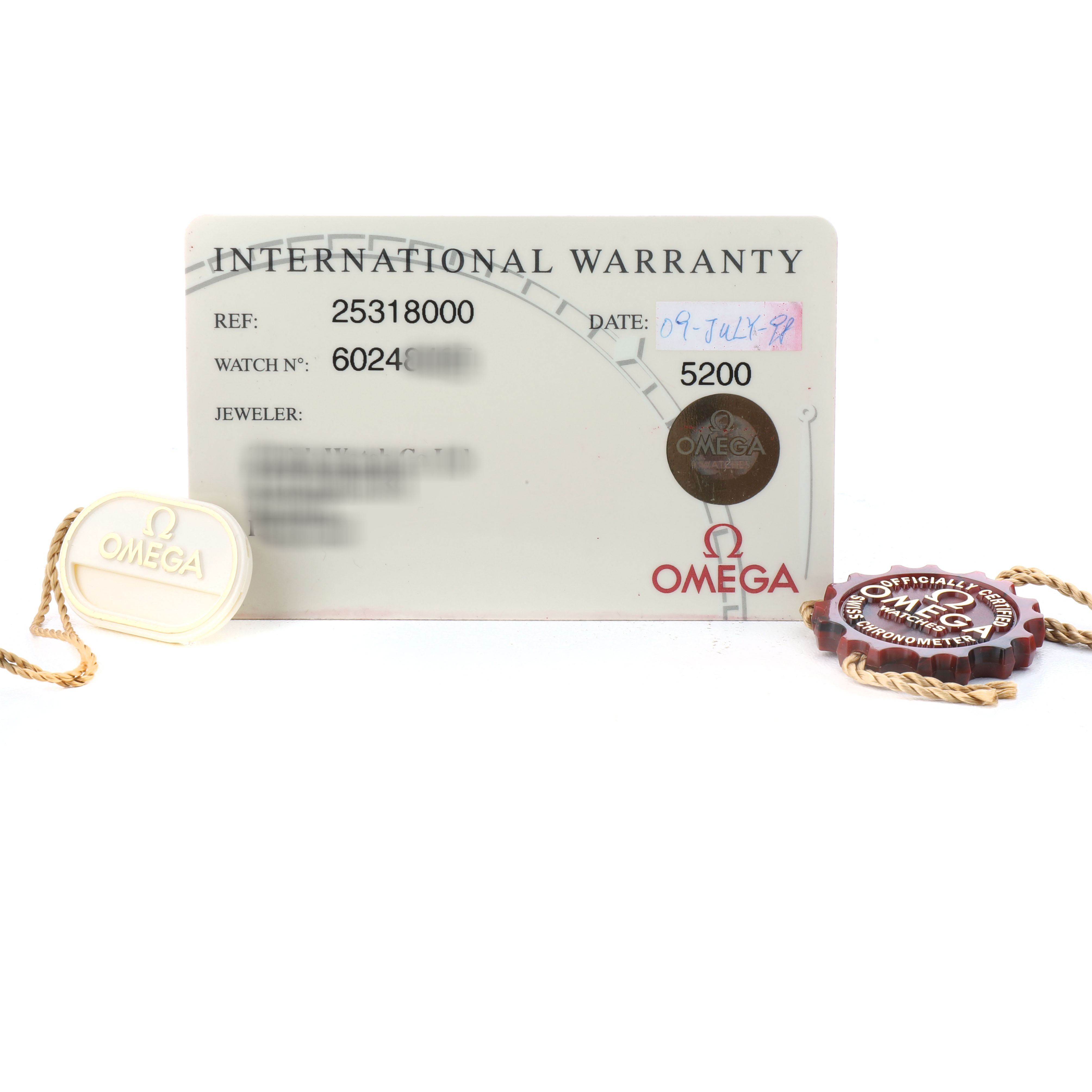 The image shows an Omega Seamaster 2531.80.00 Men's Stainless Steel Blue Dial international warranty card and two hang tags.