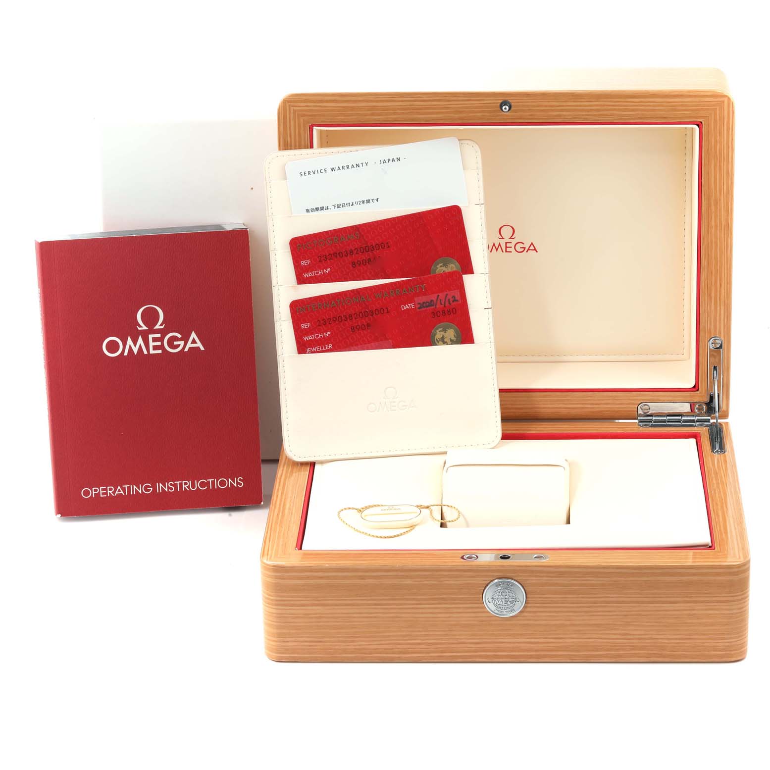 The image shows a top-view angle of Omega's Planet Ocean watch accessories including the box, cards, and manual.
