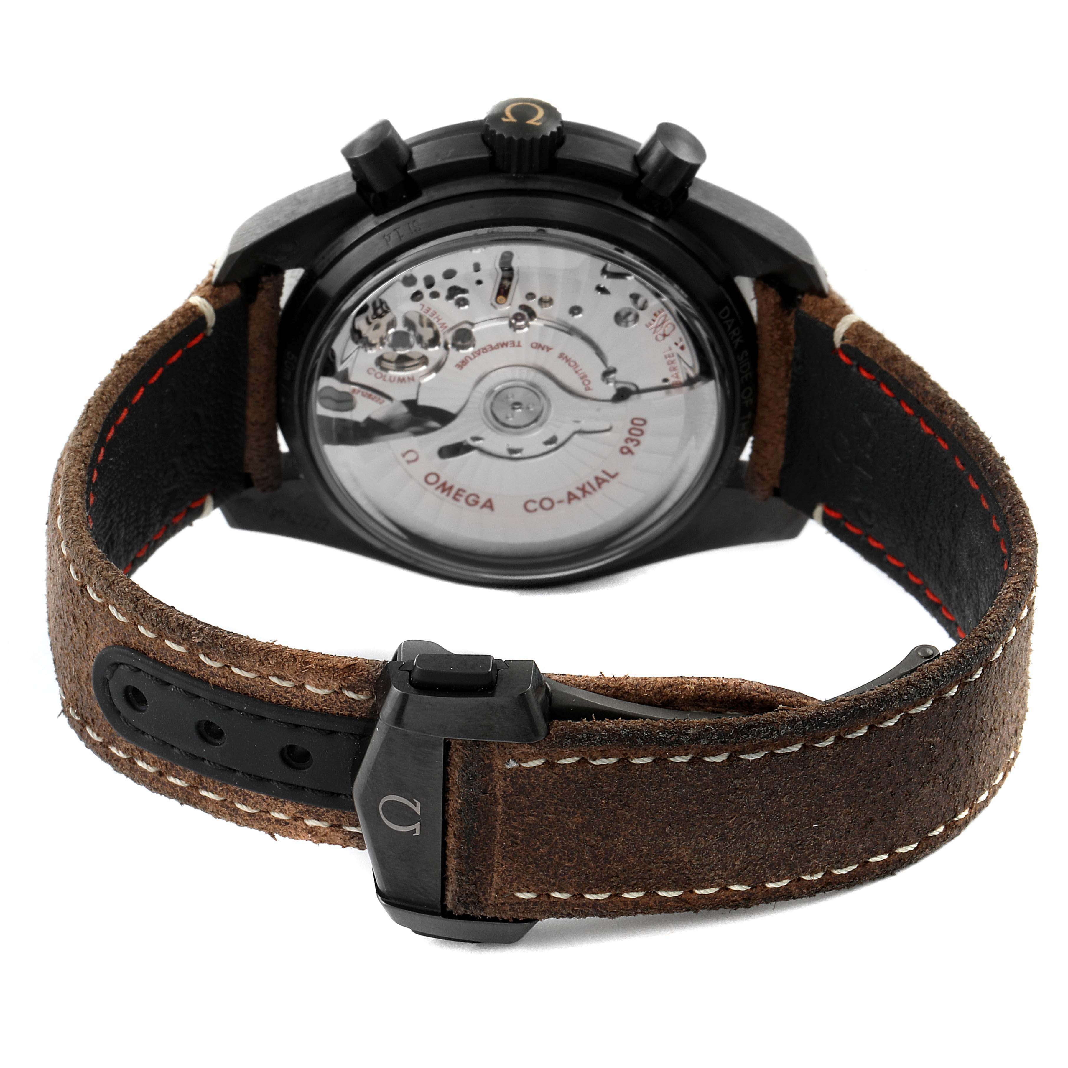 This image shows the back casing and exposed movement of the Omega Speedmaster 311.92.44.51.01.006 Men's Stainless Steel Black Dial 311.92.44.51.01.006 Men's Stainless Steel Black Dial watch, along with its leather strap and clasp.