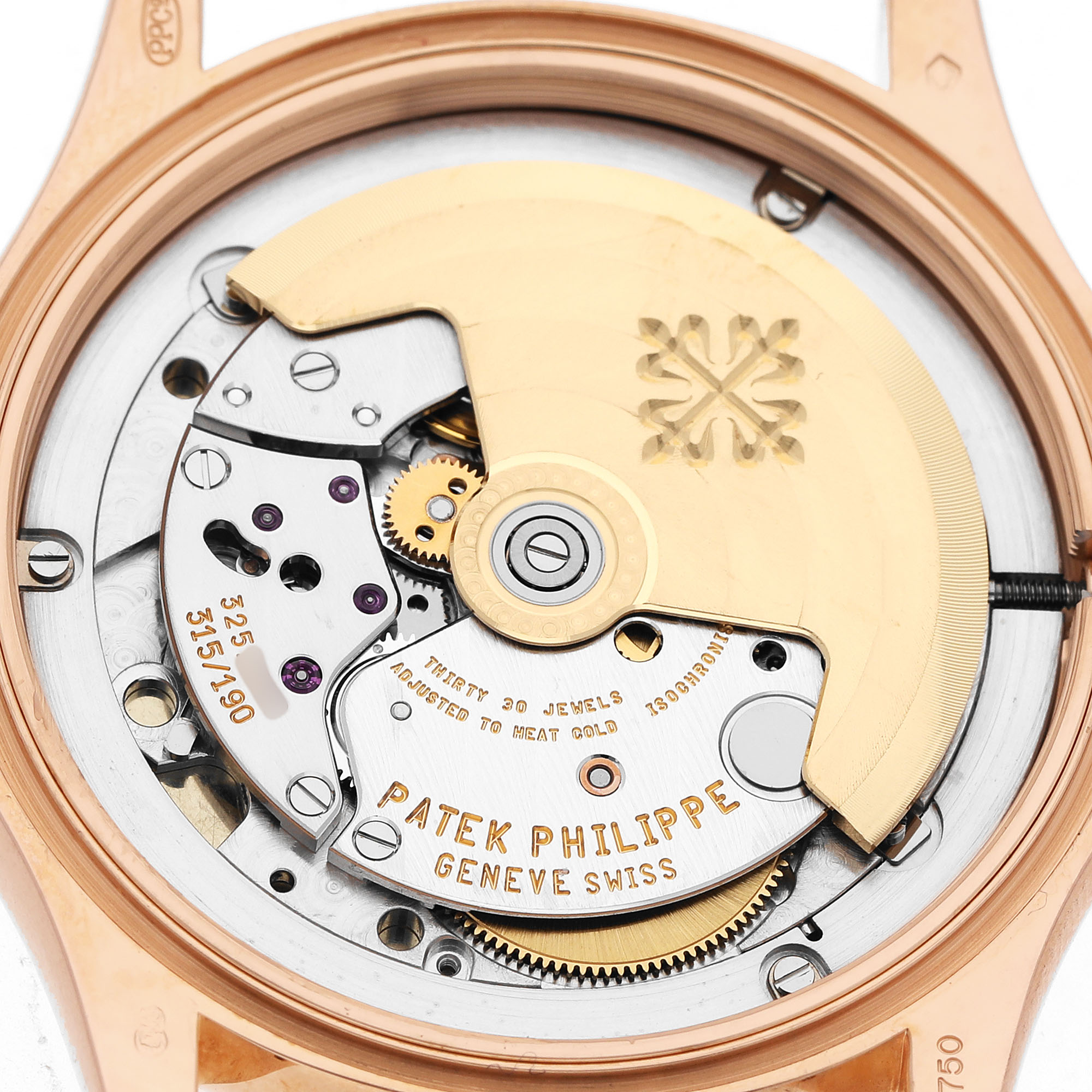 The image shows the movement of a Patek Philippe Calatrava 5117R-001 Men's Rose Gold White Dial watch from a back view, highlighting its intricate mechanics and rotor.
