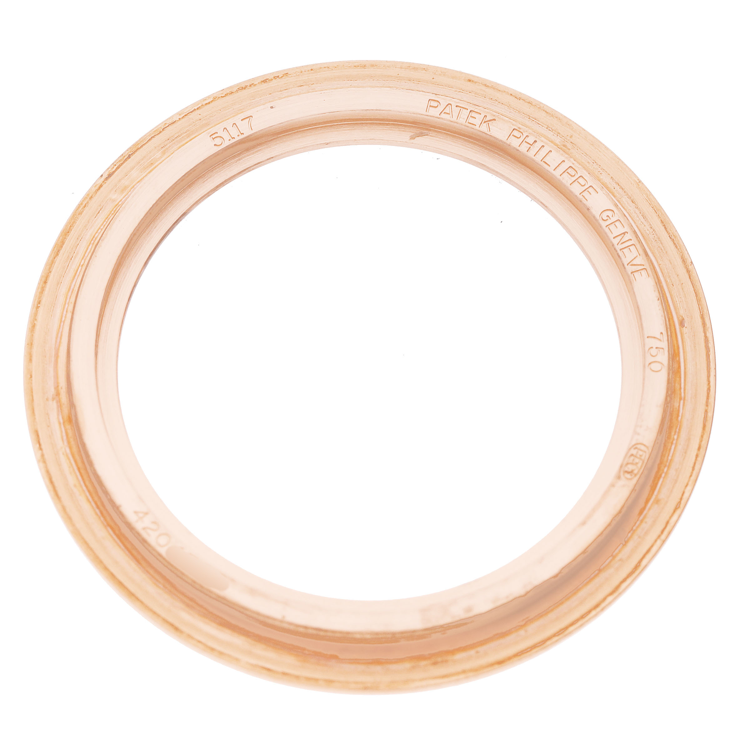 This image shows a top view of the Patek Philippe Calatrava 5117R-001 Men's Rose Gold White Dial watch bezel with engraved details.