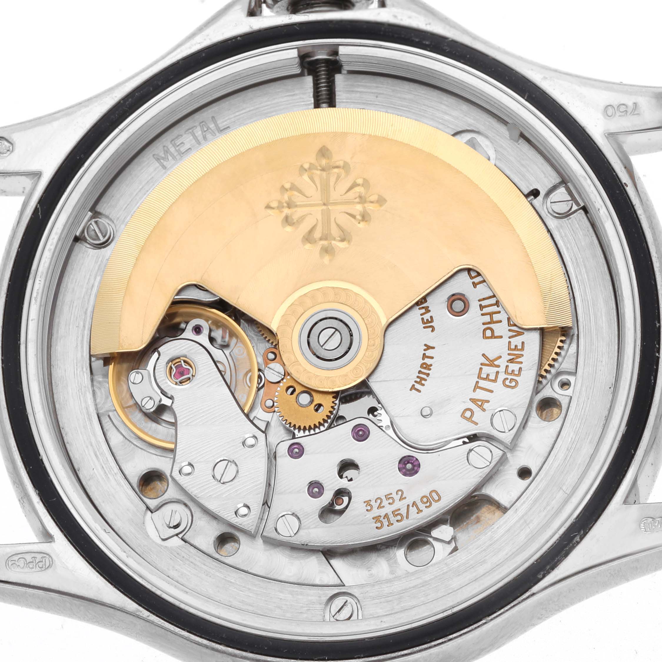 The image shows a close-up of the movement from the back of a Patek Philippe Calatrava 5117G Men
s White Gold White Dial watch, highlighting the rotor and internal components.