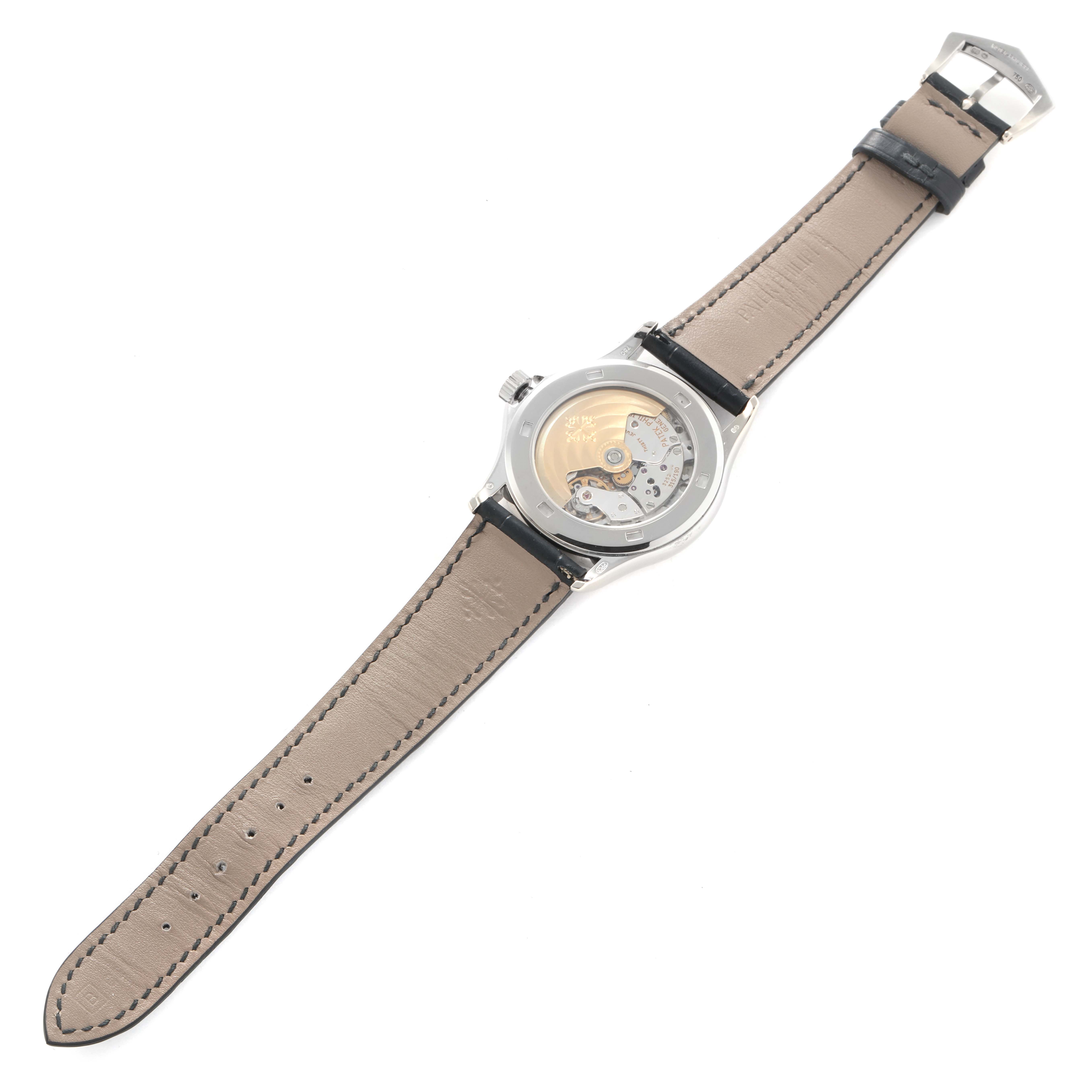 The Patek Philippe Calatrava 5117G Men
s White Gold White Dial watch is shown from the back, highlighting the transparent case back and leather strap.