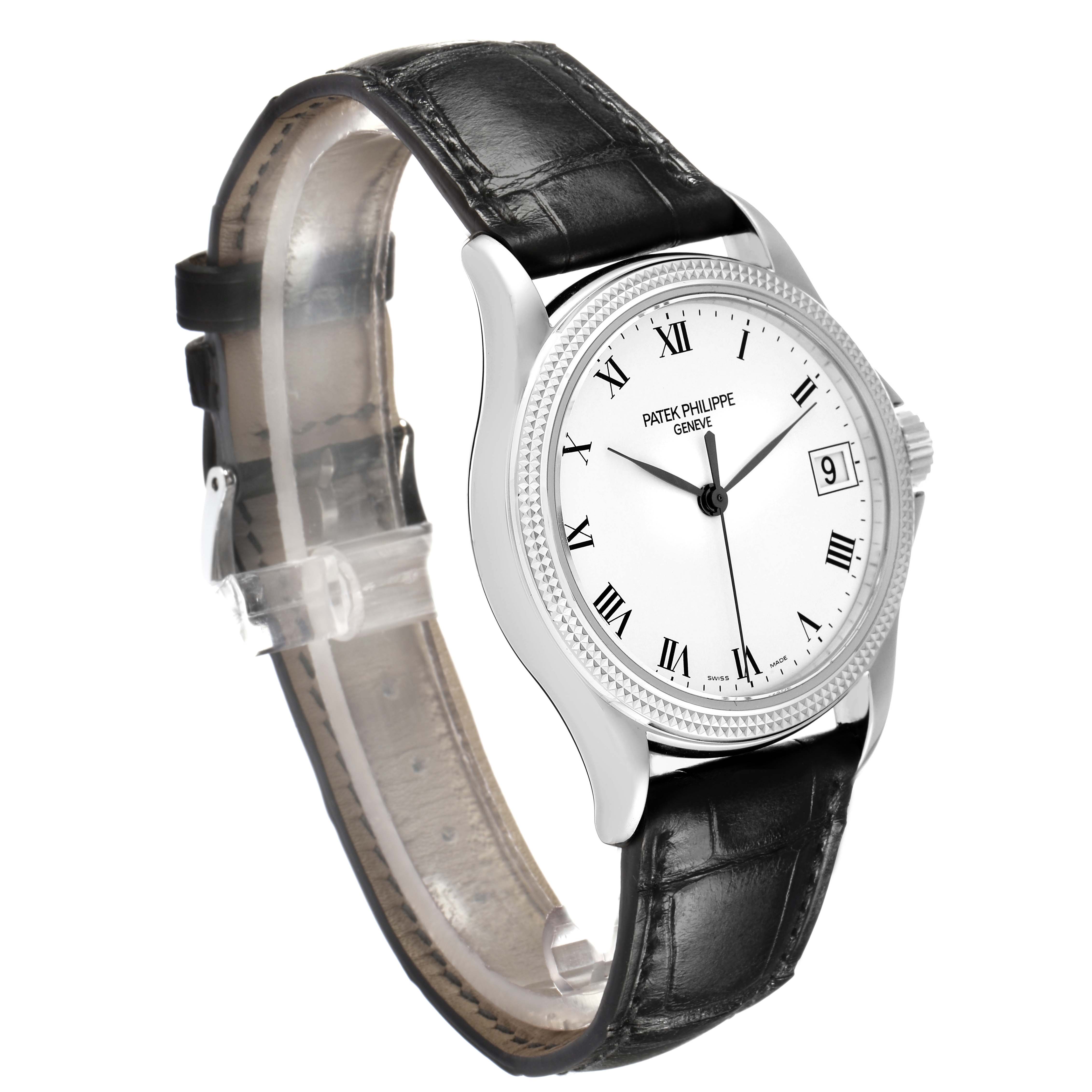 The Patek Philippe Calatrava 5117G Men
s White Gold White Dial watch is shown from a three-quarter angle, detailing its white dial, Roman numerals, bezel, and black leather strap.