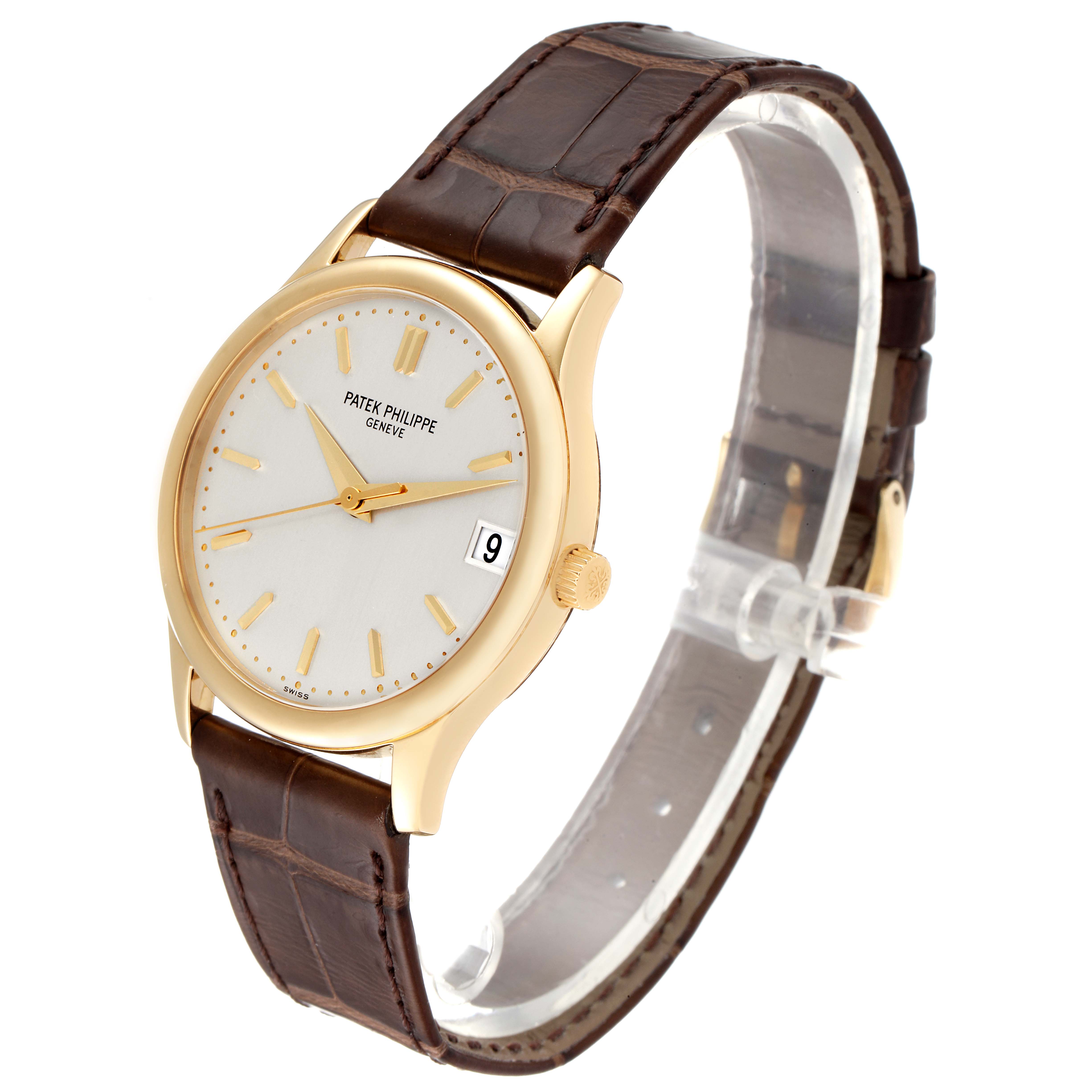This image shows a front angled view of a Patek Philippe Calatrava 3998J Men's Yellow Gold Silver Dial 3998J Men's Yellow Gold Silver Dial watch with a gold case and brown leather strap.