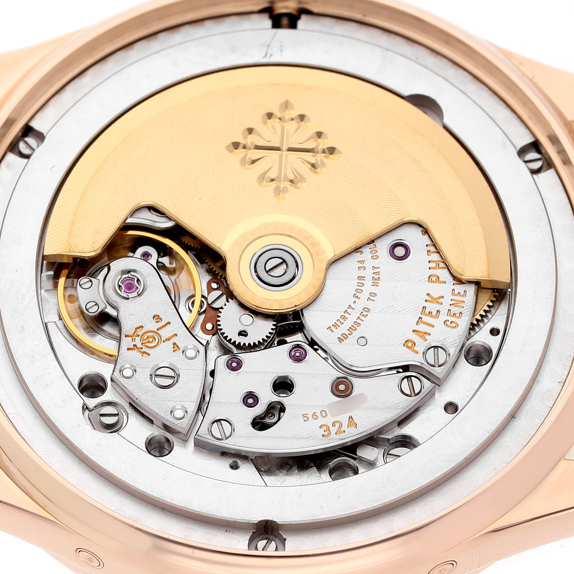 The image shows the intricate movement and rotor of a Patek Philippe Complications 5396R-001 Men's Rose Gold Silver Dial model from a back angle.