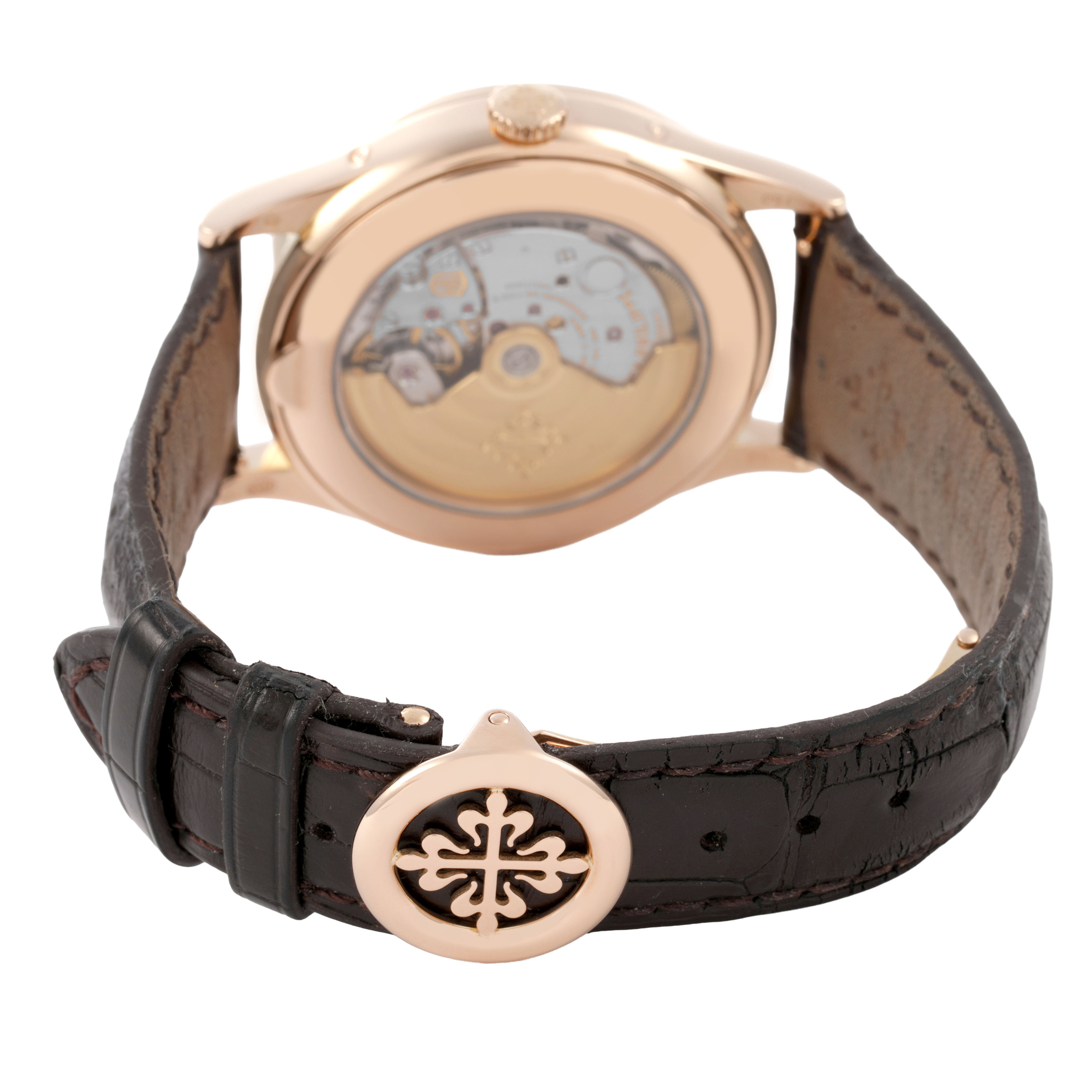 The image shows the back of a Patek Philippe Complications 5396R-001 Men's Rose Gold Silver Dial watch, highlighting the movement and leather strap with a decorative clasp.