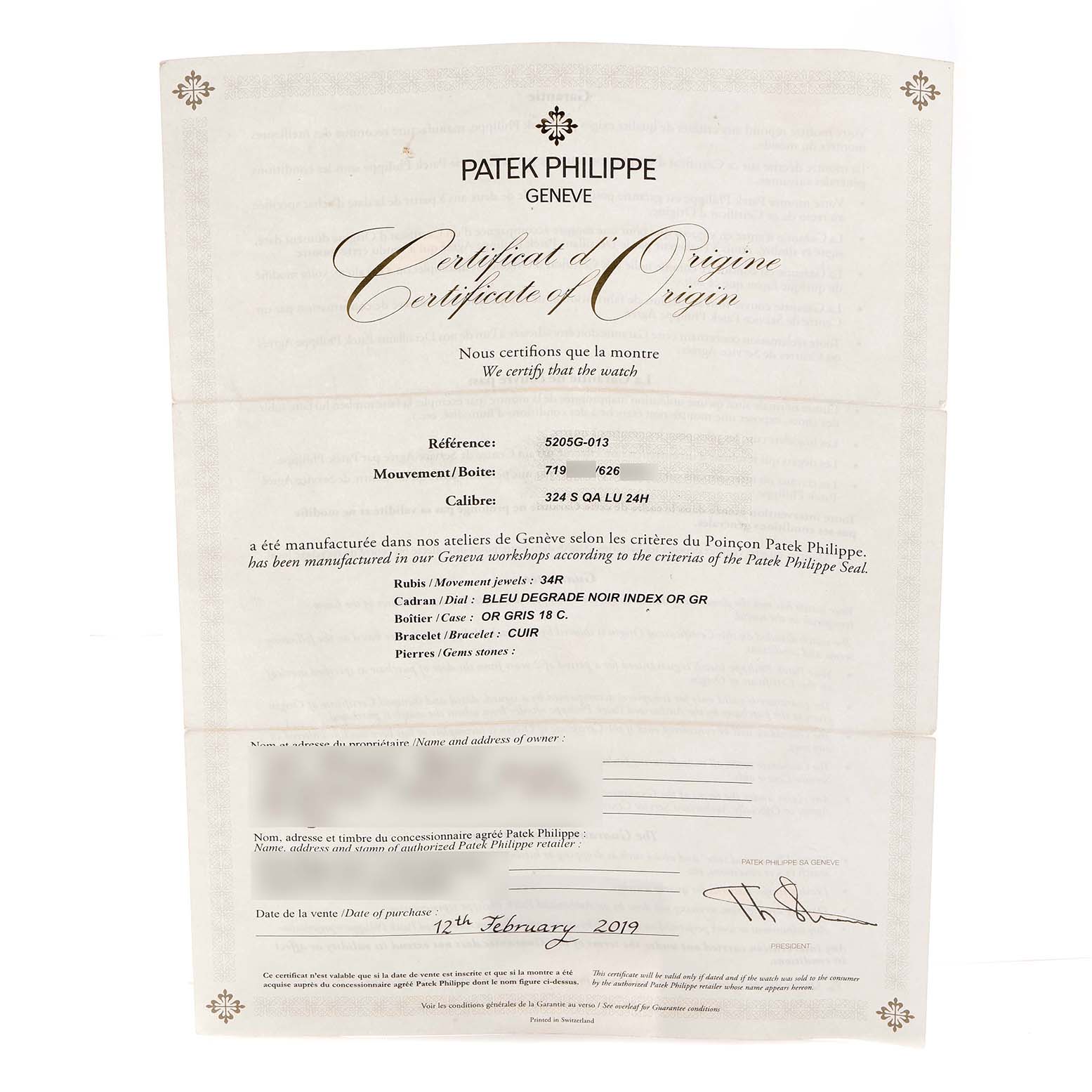 The image shows a Patek Philippe Complications 5205G-013 Men
s White Gold Blue Dial model
s Certificate of Origin document.