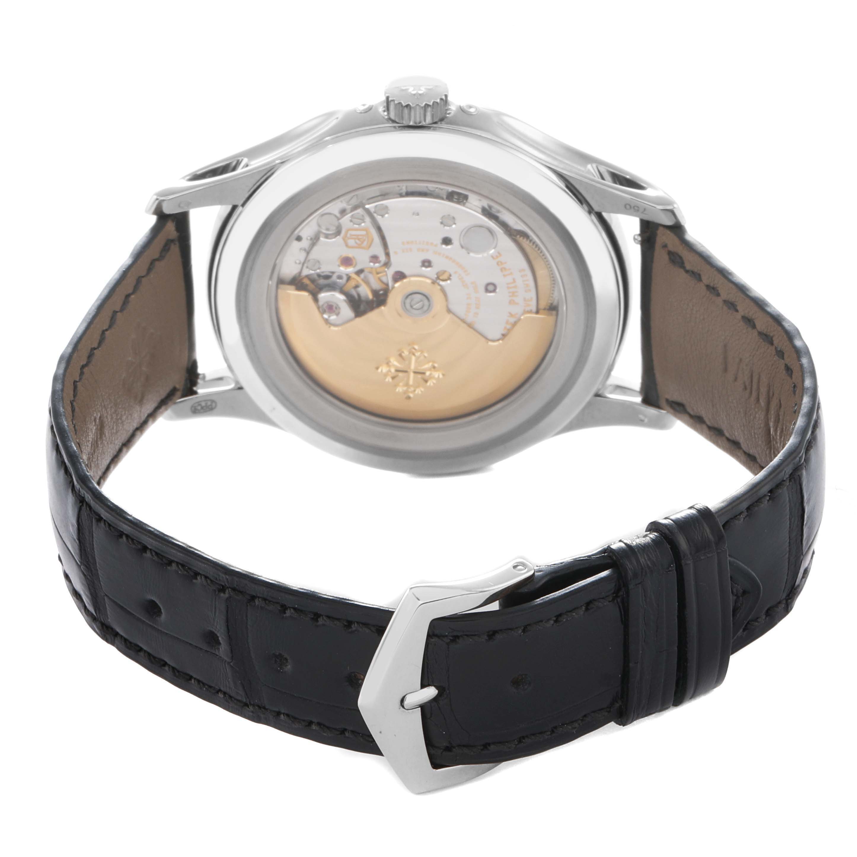 The Patek Philippe Complications 5205G-013 Men
s White Gold Blue Dial watch is shown from the back, displaying its movement and case with a leather strap.