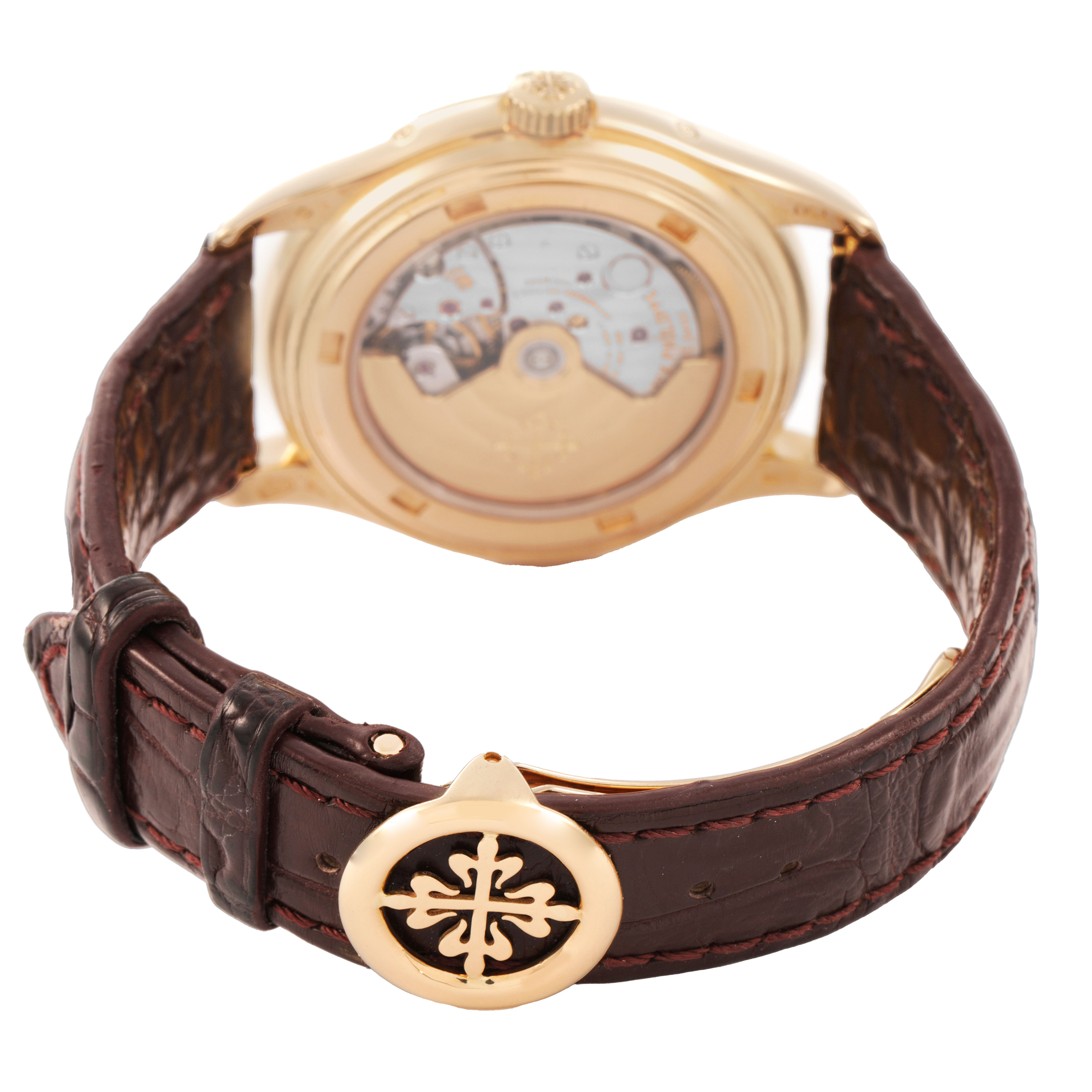 The image shows the back view of the Patek Philippe Complications 5146J-001 Men's Yellow Gold Beige Dial watch, highlighting the movement and a leather strap with a detailed clasp.