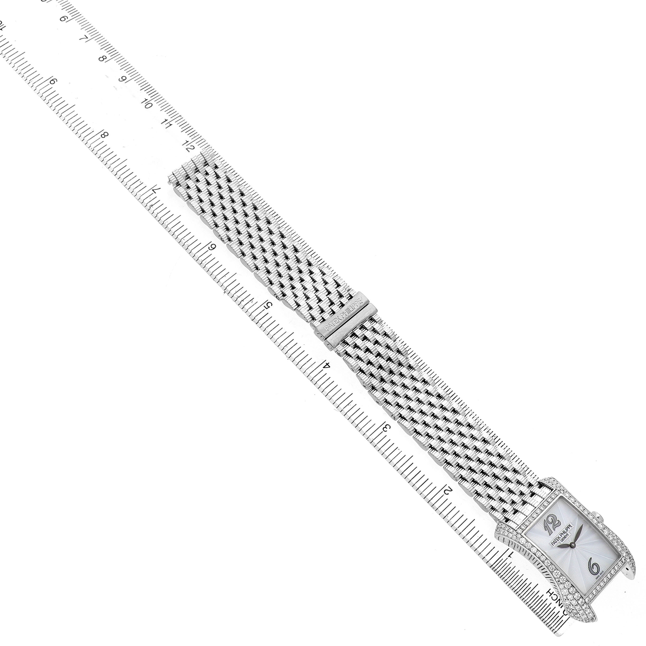 The Patek Philippe Gondolo 4972/1G-001 Women's White Gold Mother of Pearl Dial watch is shown from a top view with its face, bezel, and entire bracelet visible alongside a ruler.