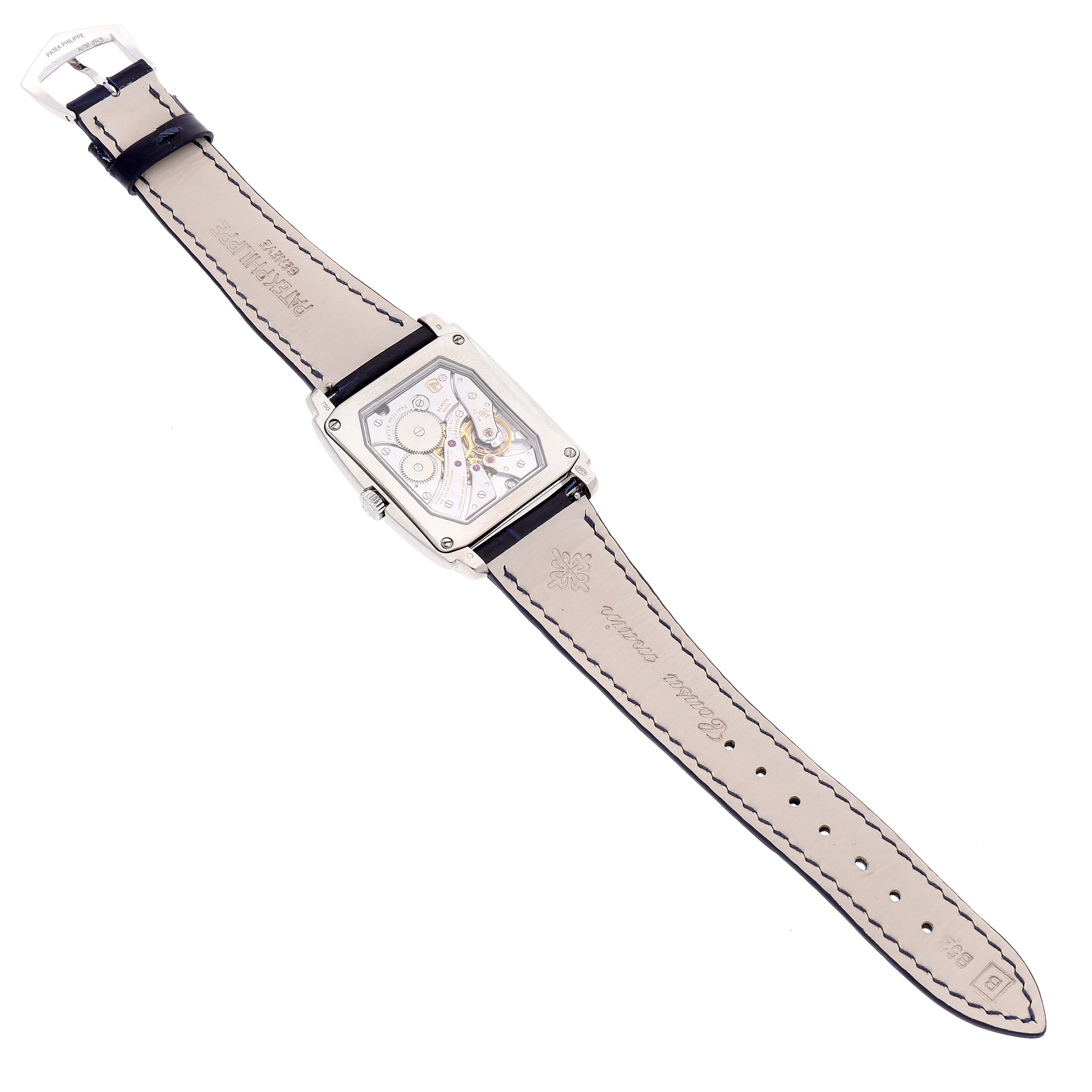 The image shows the back of a Patek Philippe Gondolo 5124G Men's White Gold Blue Dial 5124G Men's White Gold Blue Dial watch, displaying its open movement and leather strap.