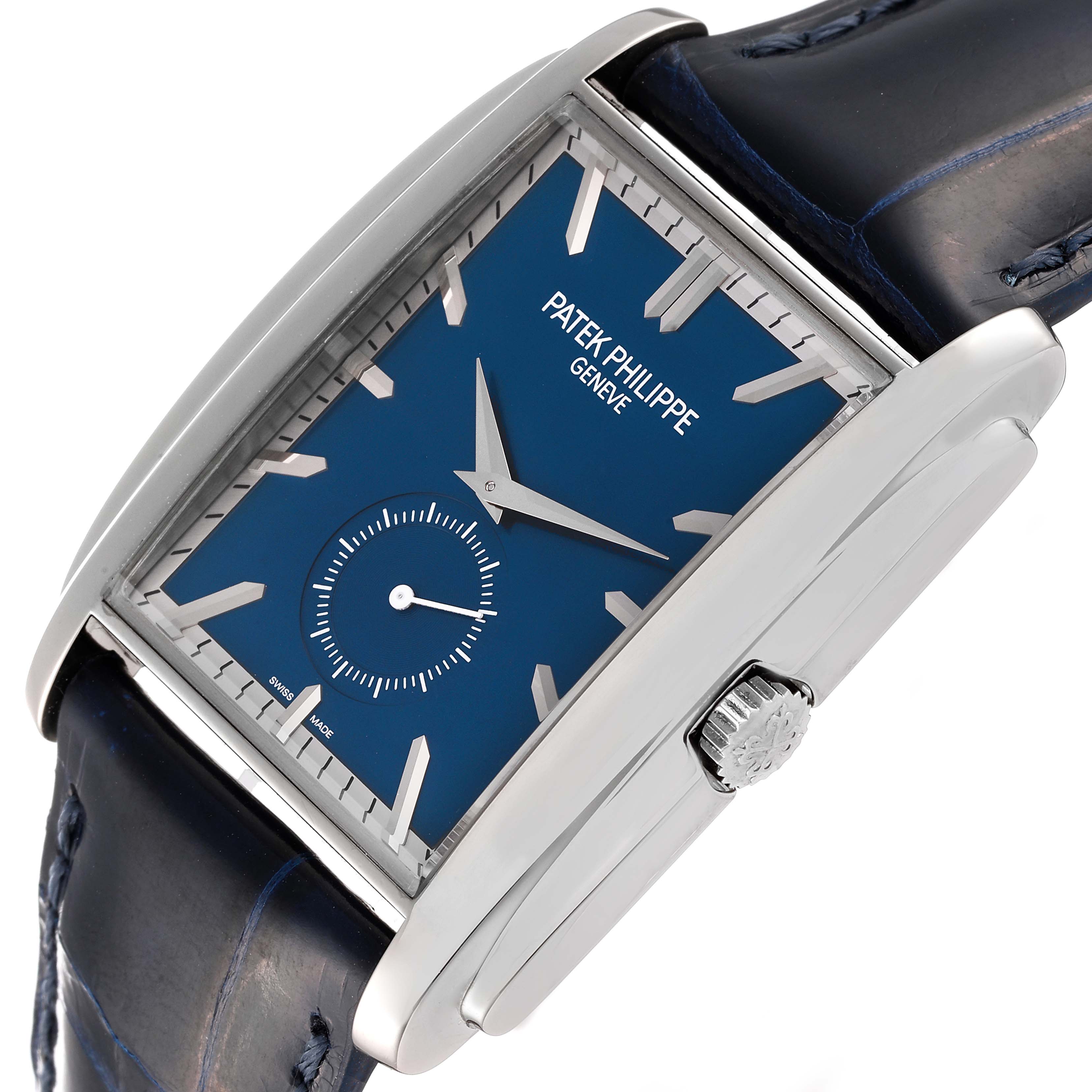 The Patek Philippe Gondolo 5124G Men's White Gold Blue Dial 5124G Men's White Gold Blue Dial watch is shown from an angled view, with a focus on its face, crown, and leather strap.