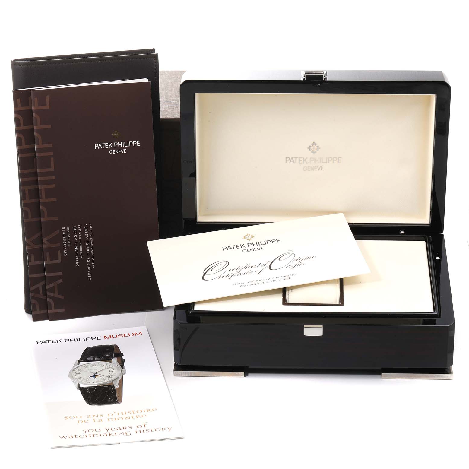 The image shows the empty packaging, guarantee certificate, and manuals for a Patek Philippe Nautilus 5712G/001 Men's White Gold Grey Dial 5712G/001 Men's White Gold Grey Dial watch, viewed from the front.