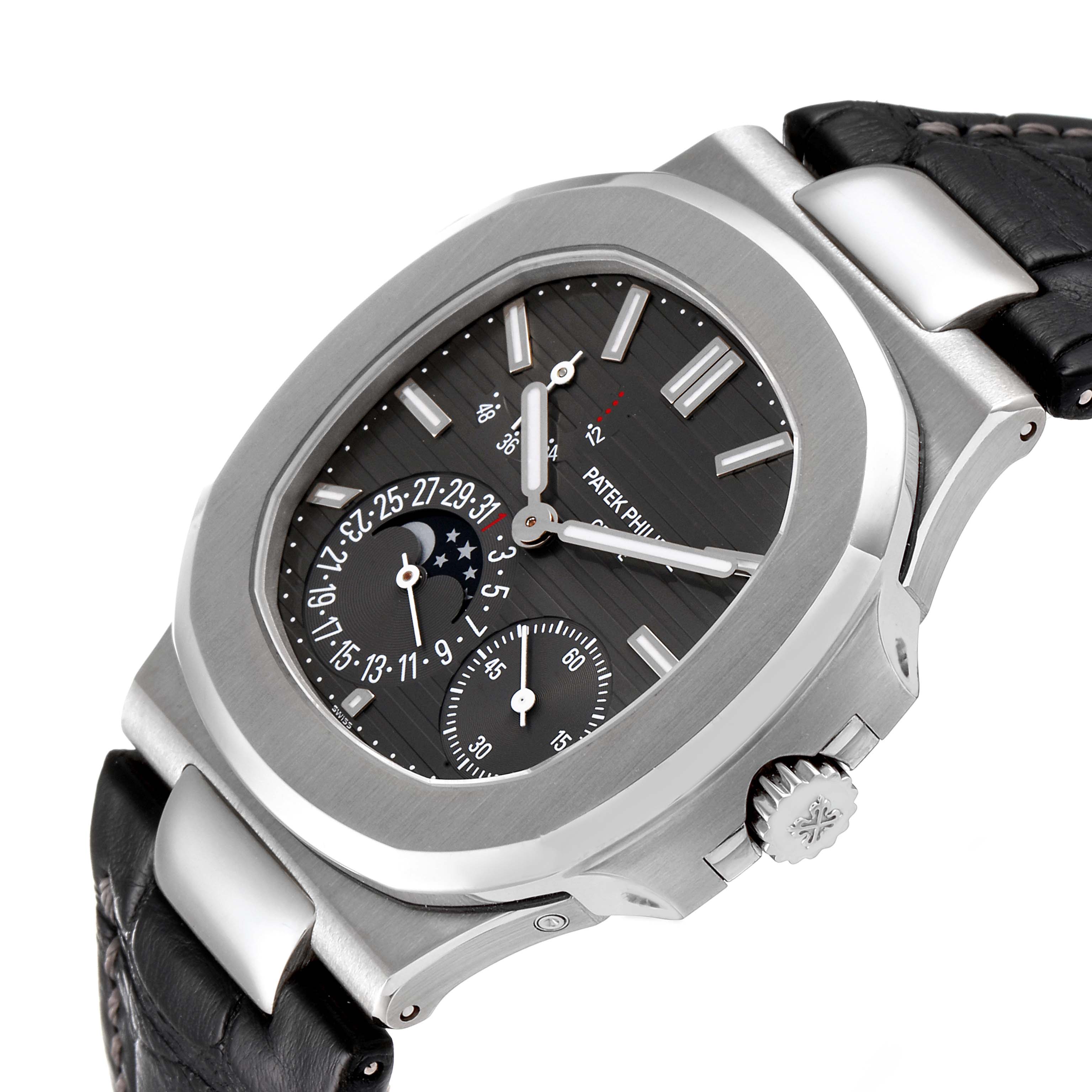 The image shows a Patek Philippe Nautilus 5712G/001 Men's White Gold Grey Dial 5712G/001 Men's White Gold Grey Dial watch at an oblique angle, highlighting the dial, case, crown, and part of the leather strap.