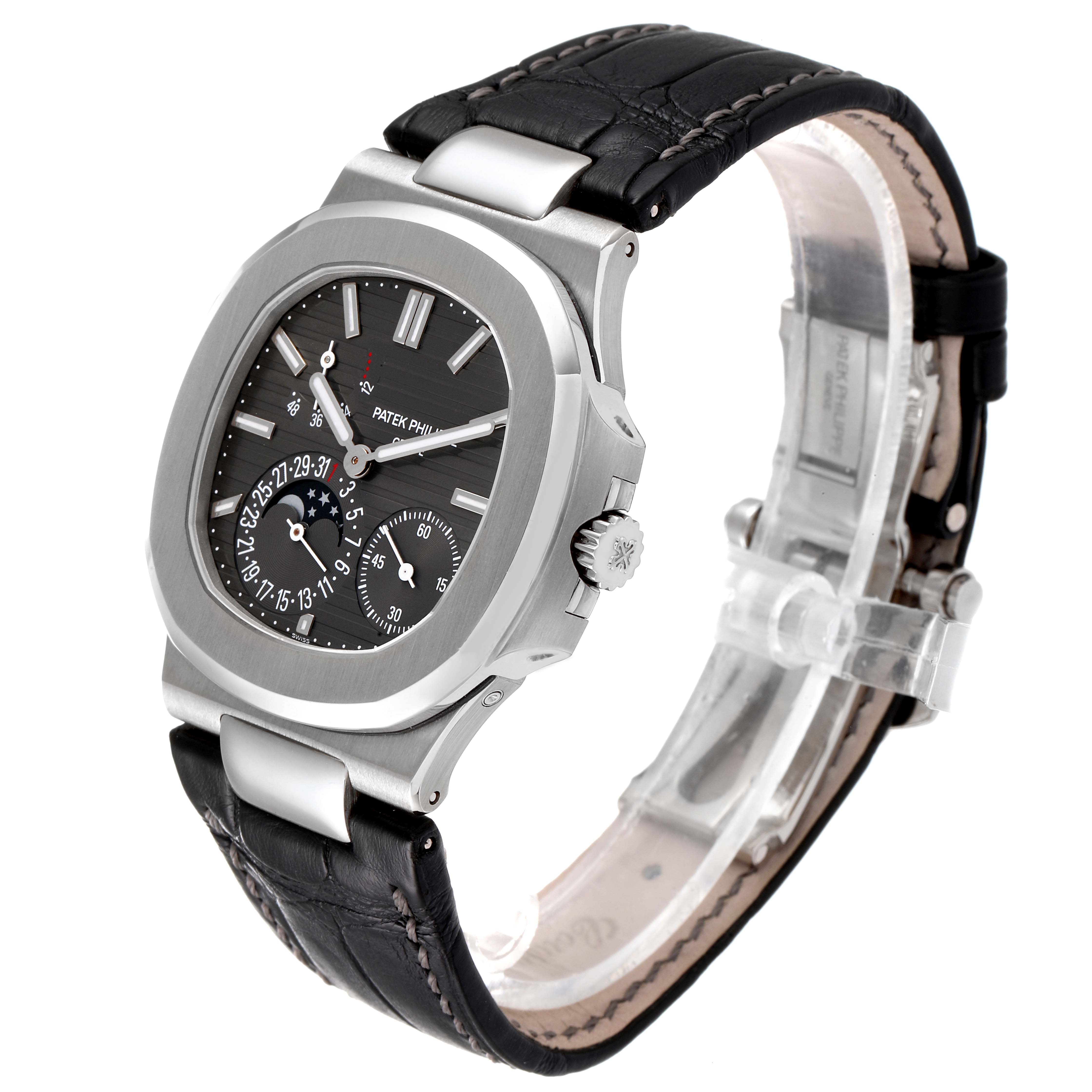 The image shows a Patek Philippe Nautilus 5712G/001 Men's White Gold Grey Dial 5712G/001 Men's White Gold Grey Dial watch at a three-quarter angle with a black leather strap and a detailed dial.
