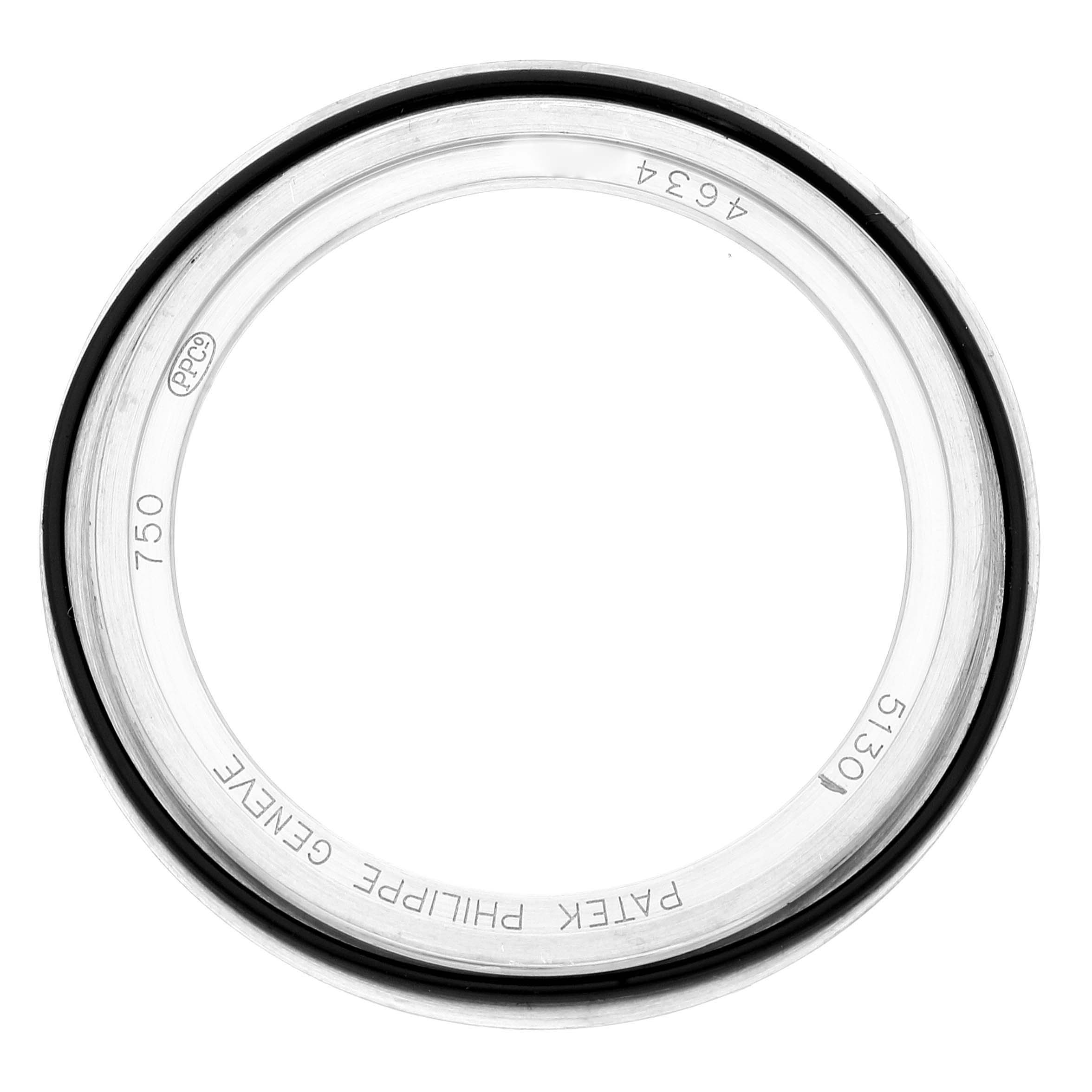 The image shows the bezel or protective glass ring of a Patek Philippe Complications 5130G-019 Men's White Gold Silver Dial 5130G-019 Men's White Gold Silver Dial model watch viewed from above.