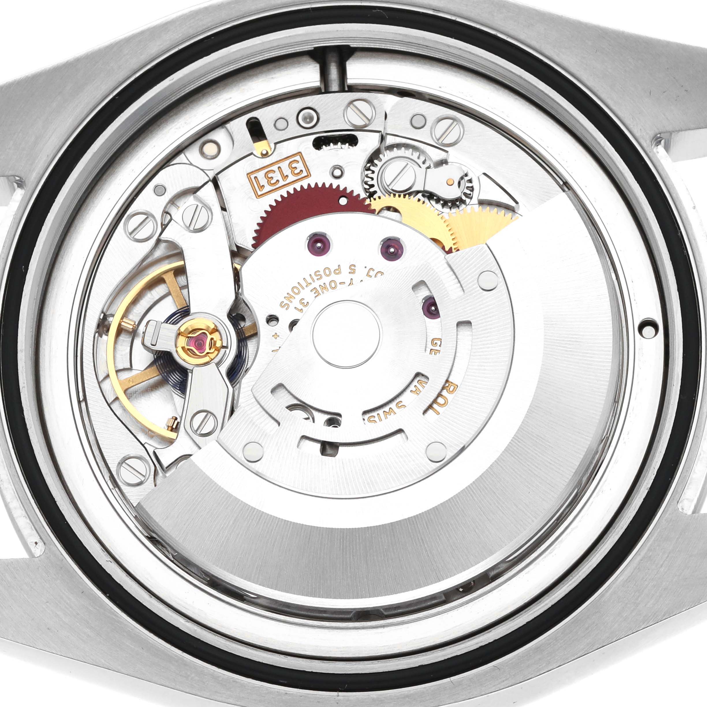 The image shows the movement mechanism of a Rolex Air-King 116900 Men
s Stainless Steel Black Dial watch viewed from the back, highlighting gears and components.