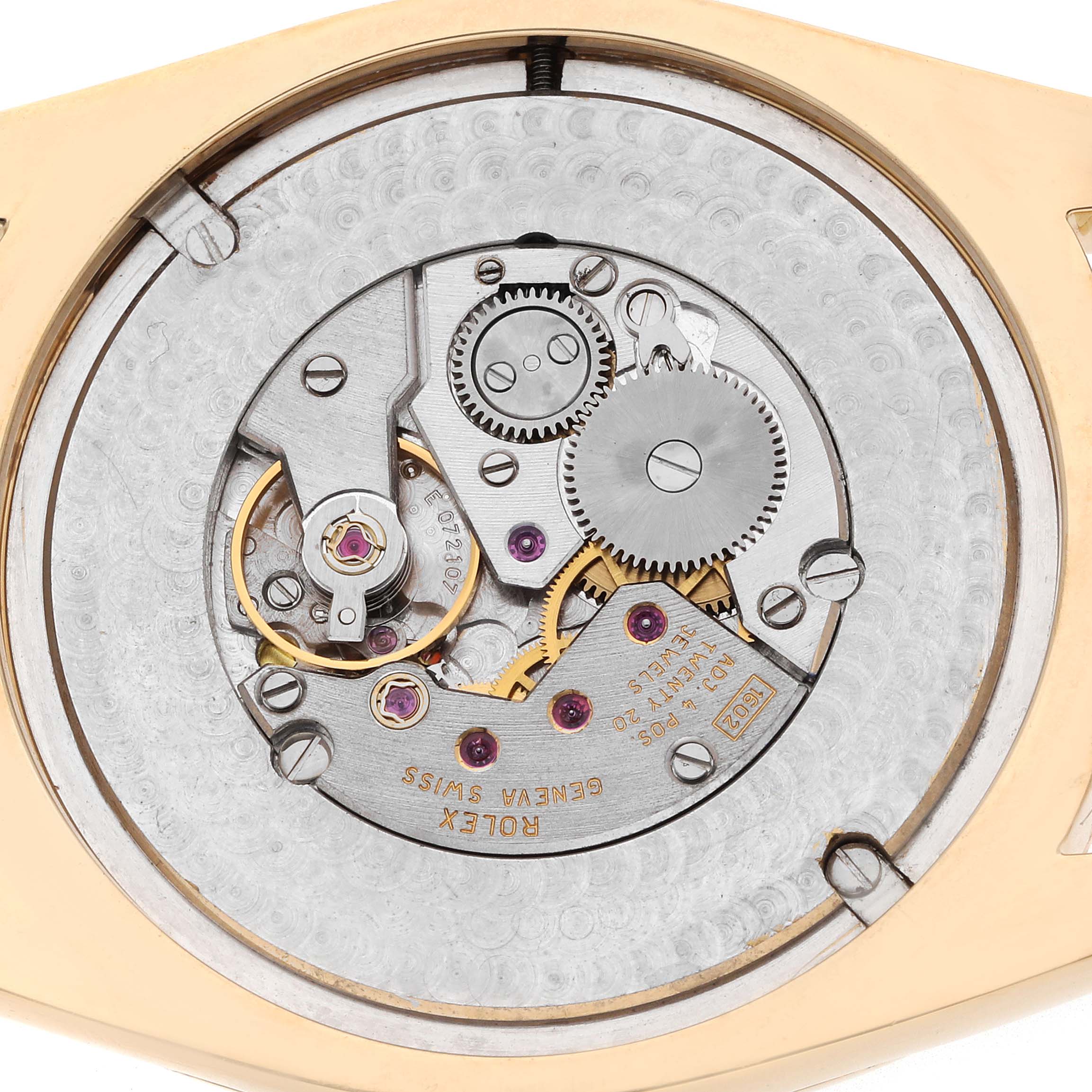 The image shows the movement and gears of a Rolex Cellini 4243 Men
s Yellow Gold Champagne Dial watch from a back view, highlighting its intricate mechanical parts.