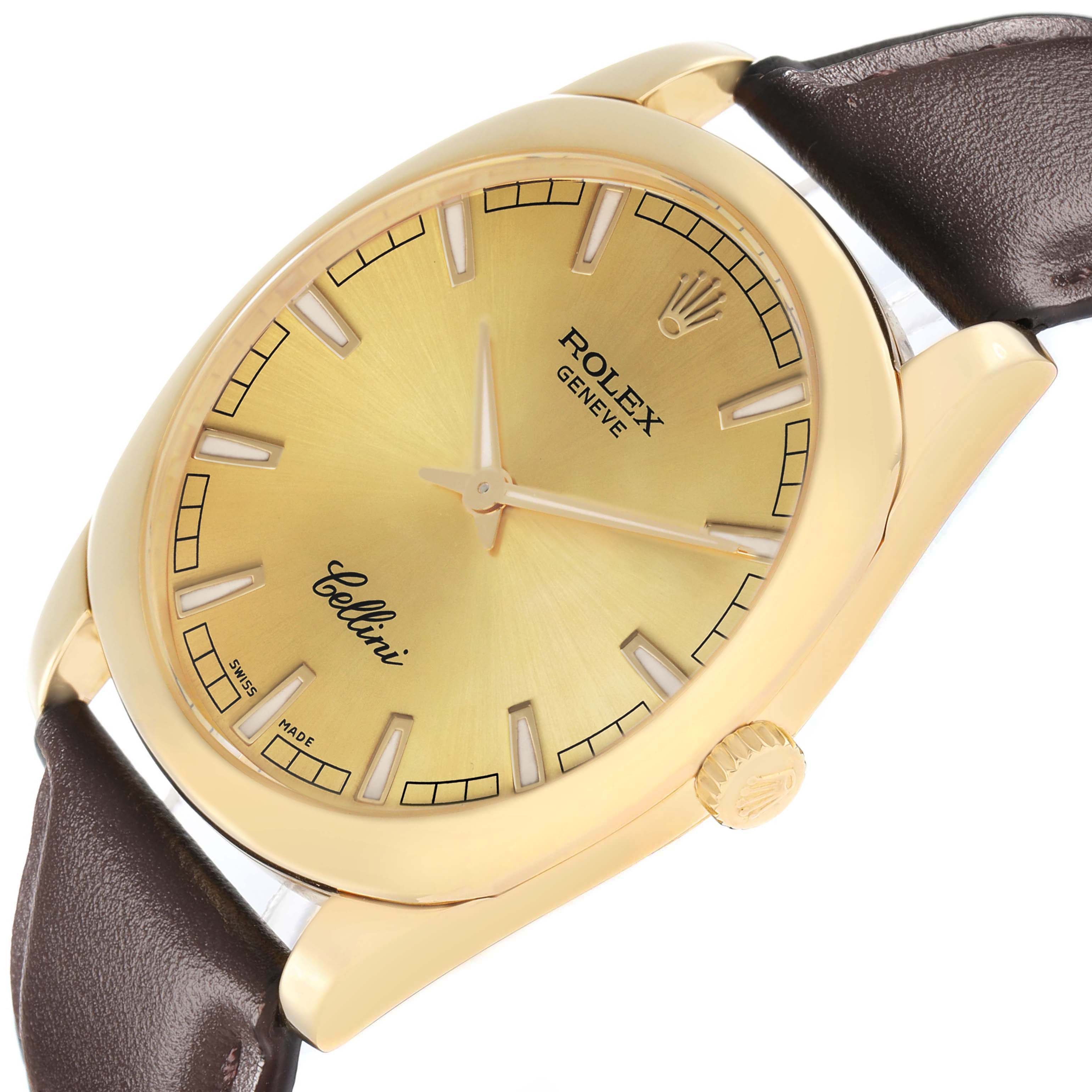 The Rolex Cellini 4243 Men
s Yellow Gold Champagne Dial watch is shown from a tilted top-down angle, highlighting the dial, case, and part of the leather strap.