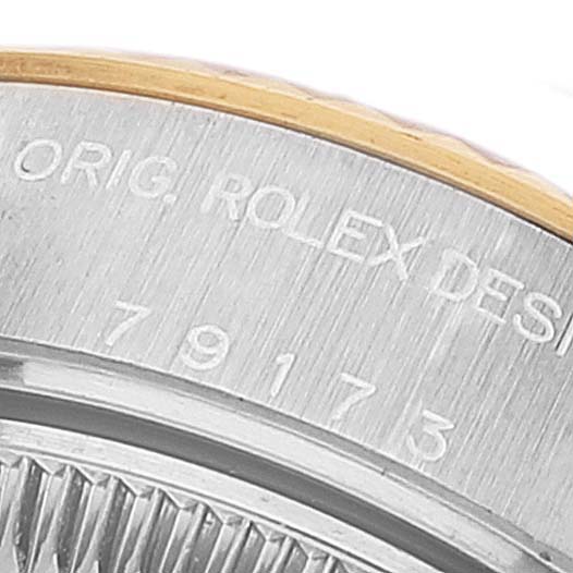 This close-up image shows the engraved model number and the edge of the bezel of a Rolex Datejust 79173 Women's Steel and Gold (two tone) White Dial 79173 Women's Steel and Gold (two tone) White Dial watch.