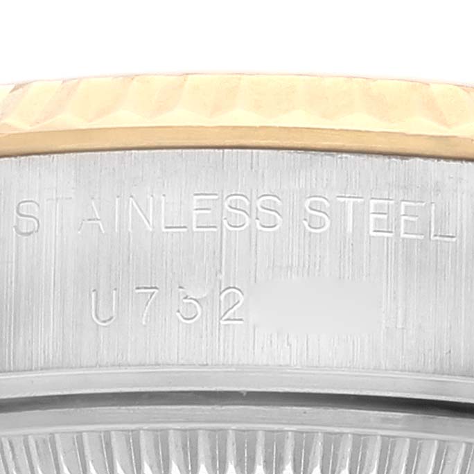 This close-up image of the Rolex Datejust 69173 Women's Steel and Gold (two tone) Champagne Dial 69173 Women's Steel and Gold (two tone) Champagne Dial model showcases the watch's stainless steel case and part of the bezel, along with visible engraving.