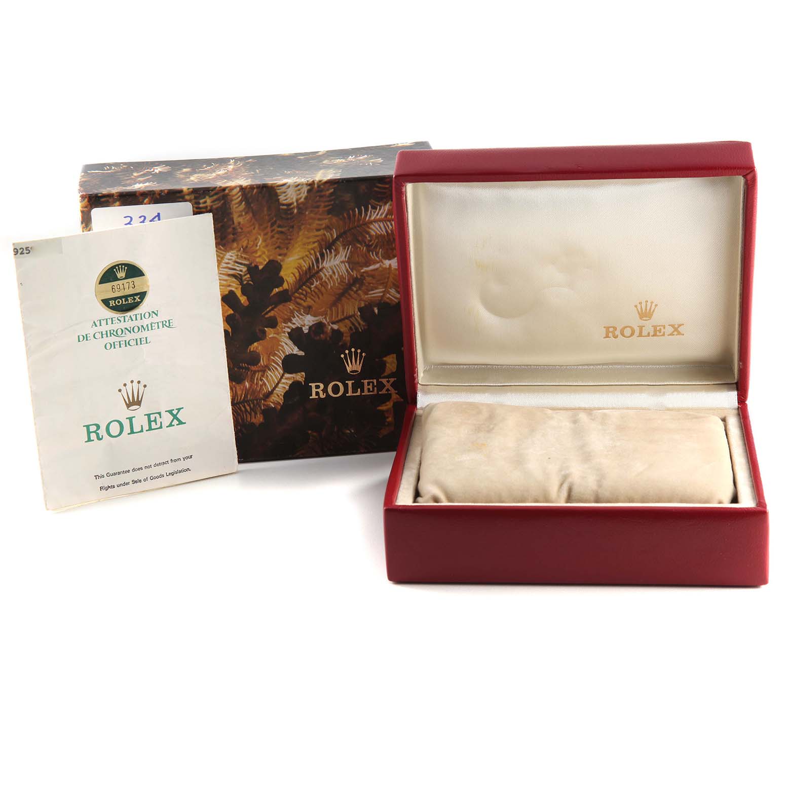 The image shows the packaging, including a box, a watch case, and an official certificate for a Datejust model by Rolex.