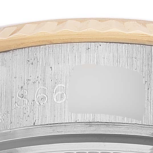 This close-up image shows the bezel and part of the casing with the serial number of a Rolex Datejust 69173 Women's Steel and Gold (two tone) White Dial 69173 Women's Steel and Gold (two tone) White Dial watch.