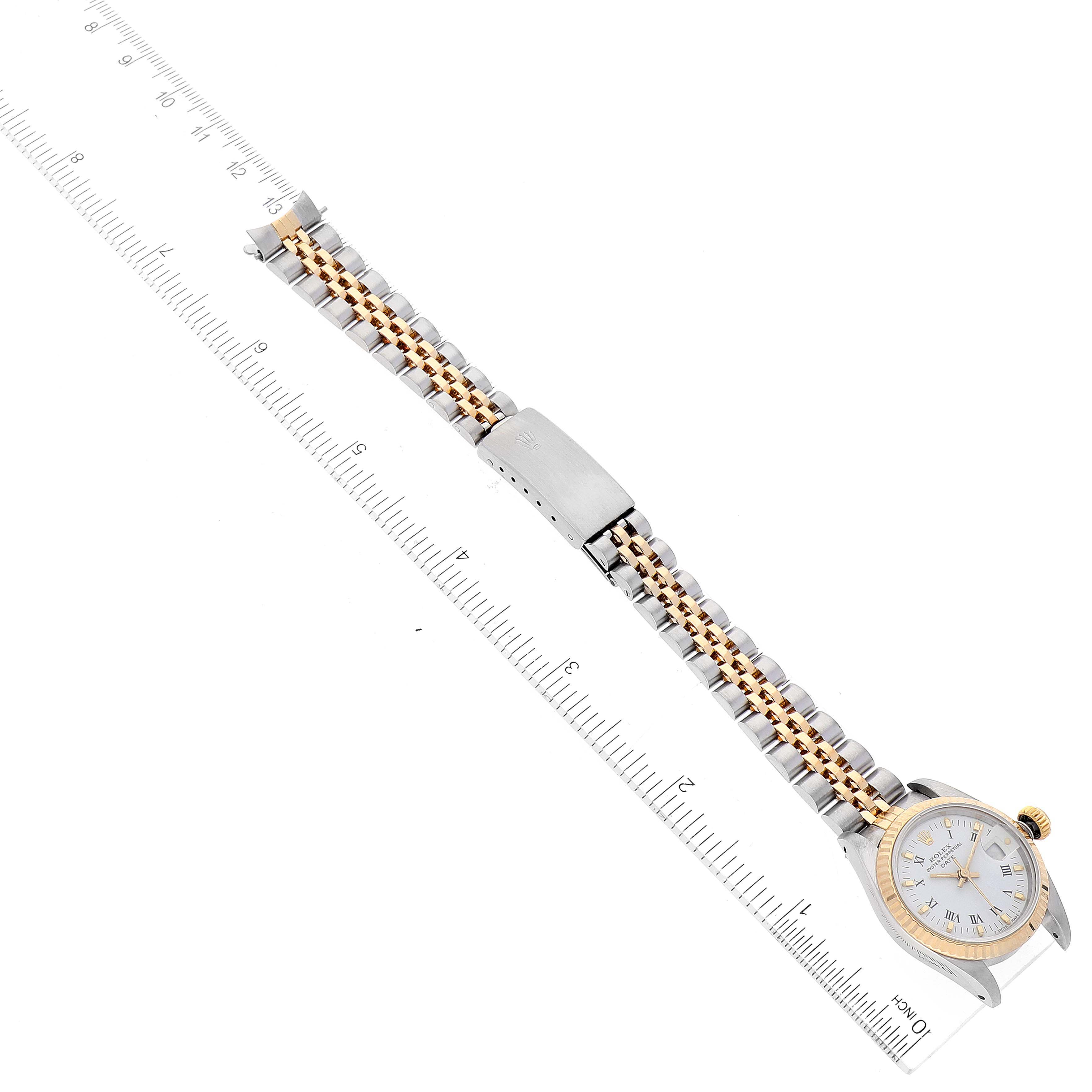 The image shows a Rolex Datejust 69173 Women's Steel and Gold (two tone) White Dial 69173 Women's Steel and Gold (two tone) White Dial watch laid flat with a metal bracelet, alongside a ruler for size reference, viewed from an overhead angle.