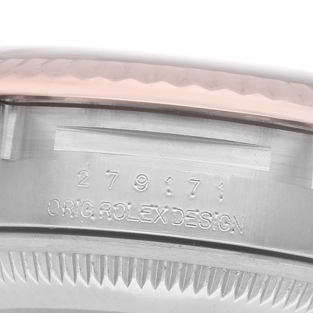 The image shows a close-up of the side of a Rolex Datejust 279171 Women
s Steel and Gold (two tone) Pink Dial watch, displaying model engraving and part of the fluted bezel.