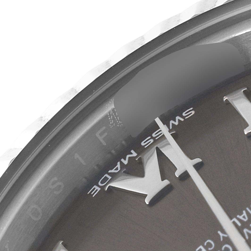 This close-up image of the Rolex Datejust 279174 Women's Stainless Steel Grey Dial 279174 Women's Stainless Steel Grey Dial watch shows part of the dial and the fluted bezel.