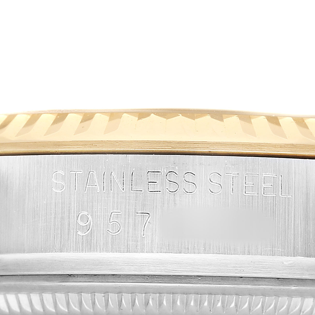 This image shows a close-up of the side of a Rolex Datejust 16013 Men's Steel and Gold (two tone) Champagne Dial watch, featuring its stainless steel and gold bezel.