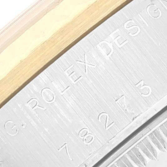 This is a close-up angle of the casing edge and part of the bezel with 
ROLEX DESIGN
 and model number engraved on a Rolex Mid-Size 78273 Women
s Steel and Gold (two tone) Champagne Dial 78273 Women
s Steel and Gold (two tone) Champagne Dial watch.