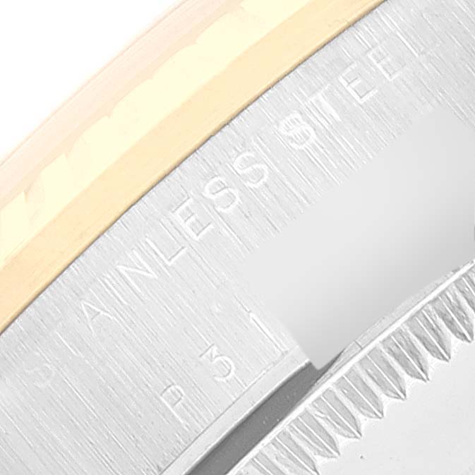 The image shows a close-up of the bezel and a portion of the case with engraved text "STAINLESS STEEL" on a Rolex Mid-Size 78273 Women
s Steel and Gold (two tone) Champagne Dial 78273 Women
s Steel and Gold (two tone) Champagne Dial model watch.