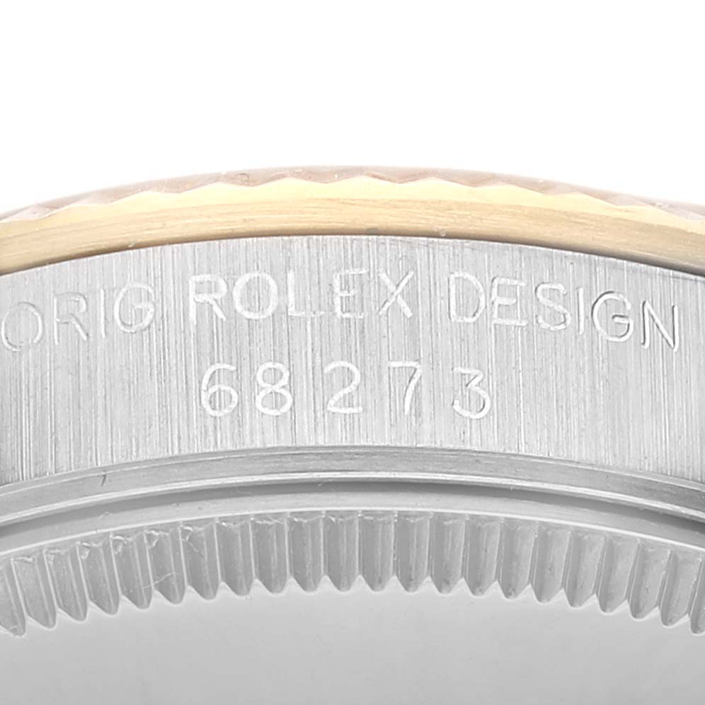 This close-up image shows the side engraving and bezel detail of a Mid-Size Rolex watch, including the model number 68273.