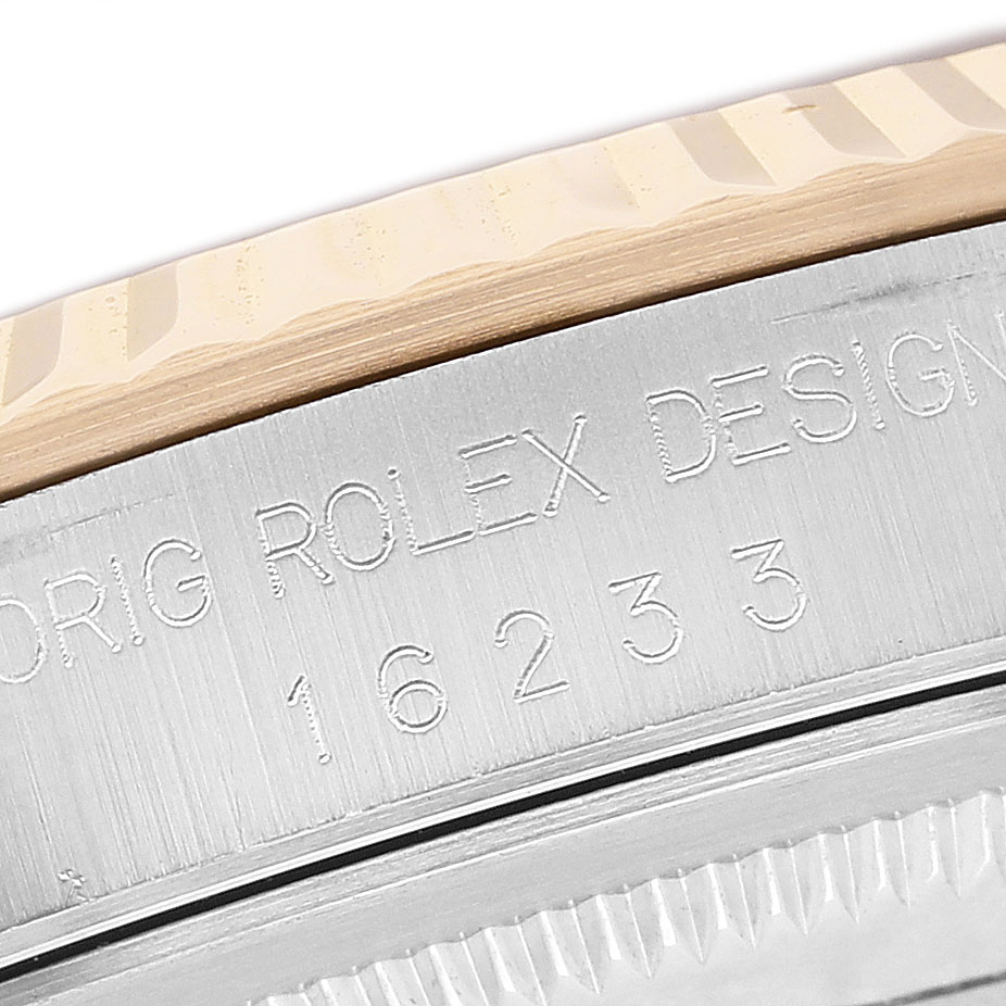 The image shows a close-up angle of the Rolex Datejust 16233 Men's Steel and Gold (two tone) Blue Dial case edge with engraved model number and bezel detail.