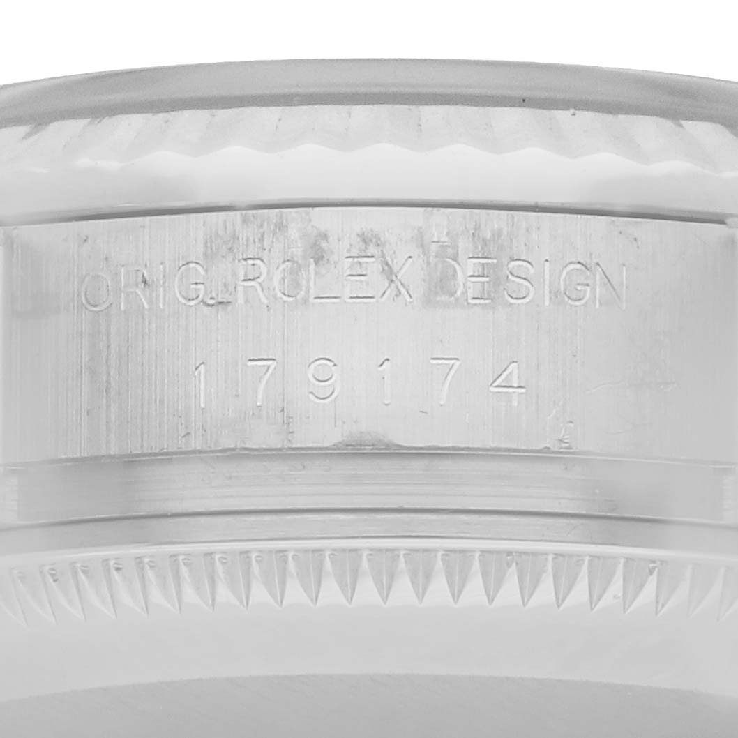 The image shows a close-up of a Rolex Datejust 179174 Women
s Stainless Steel Silver Dial case, highlighting its engraved design number.