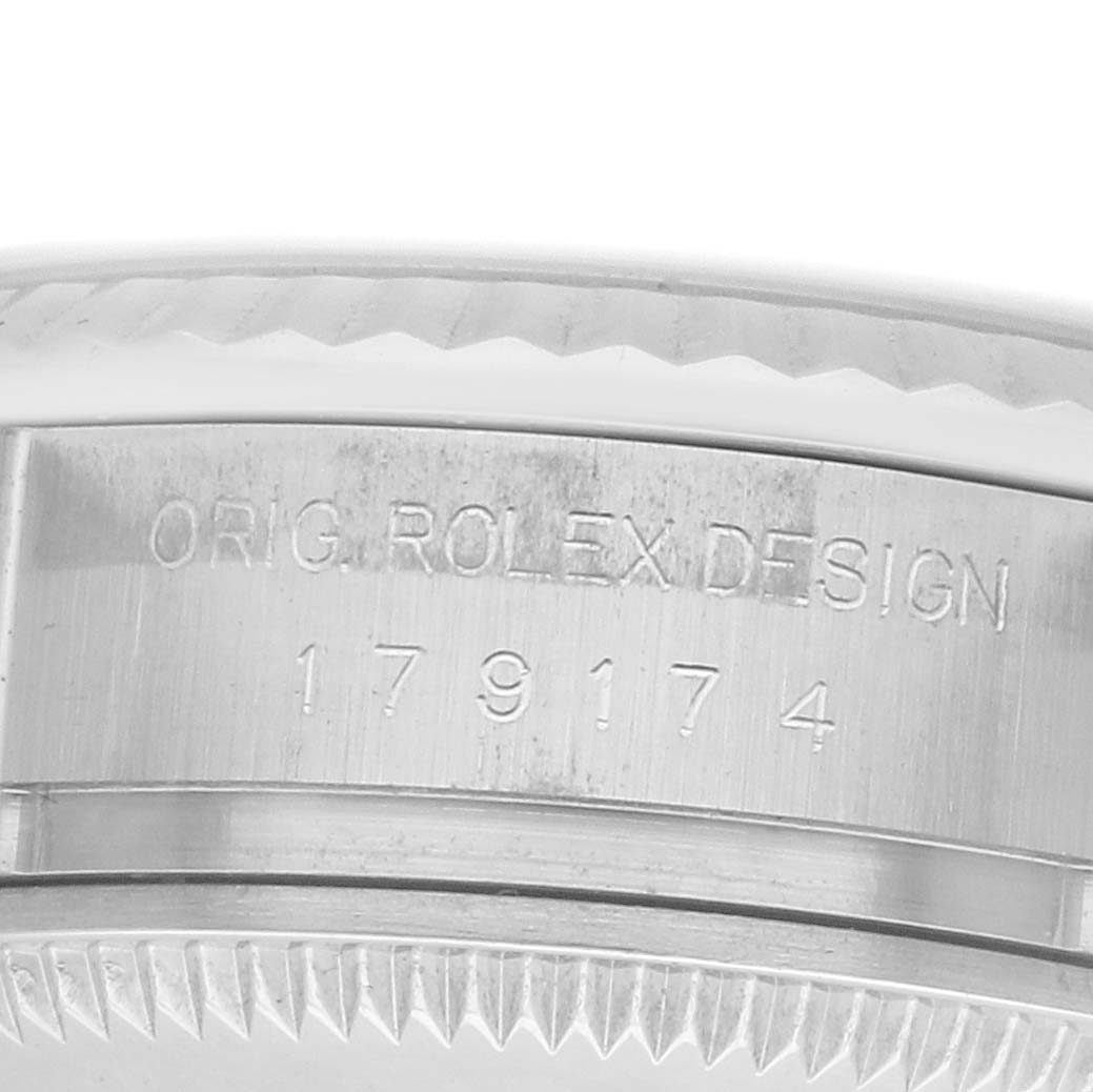 The image shows a close-up of the side of a Rolex Datejust 179174 Men
s Stainless Steel Mother of Pearl Dial, highlighting the engraved model number on the case.