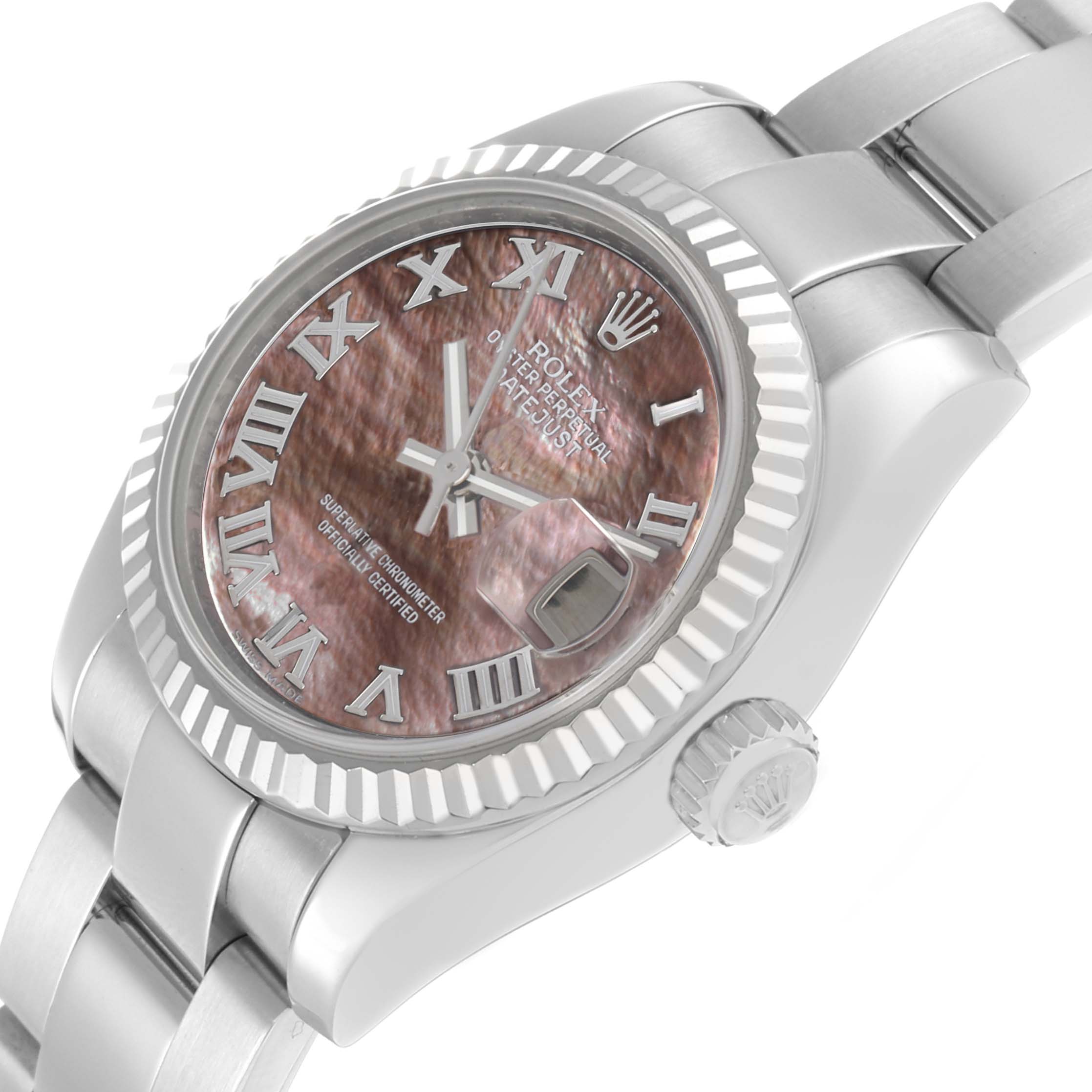 The Rolex Datejust 179174 Men
s Stainless Steel Mother of Pearl Dial watch is shown at a slight angle highlighting the face, fluted bezel, crown, and part of the bracelet.