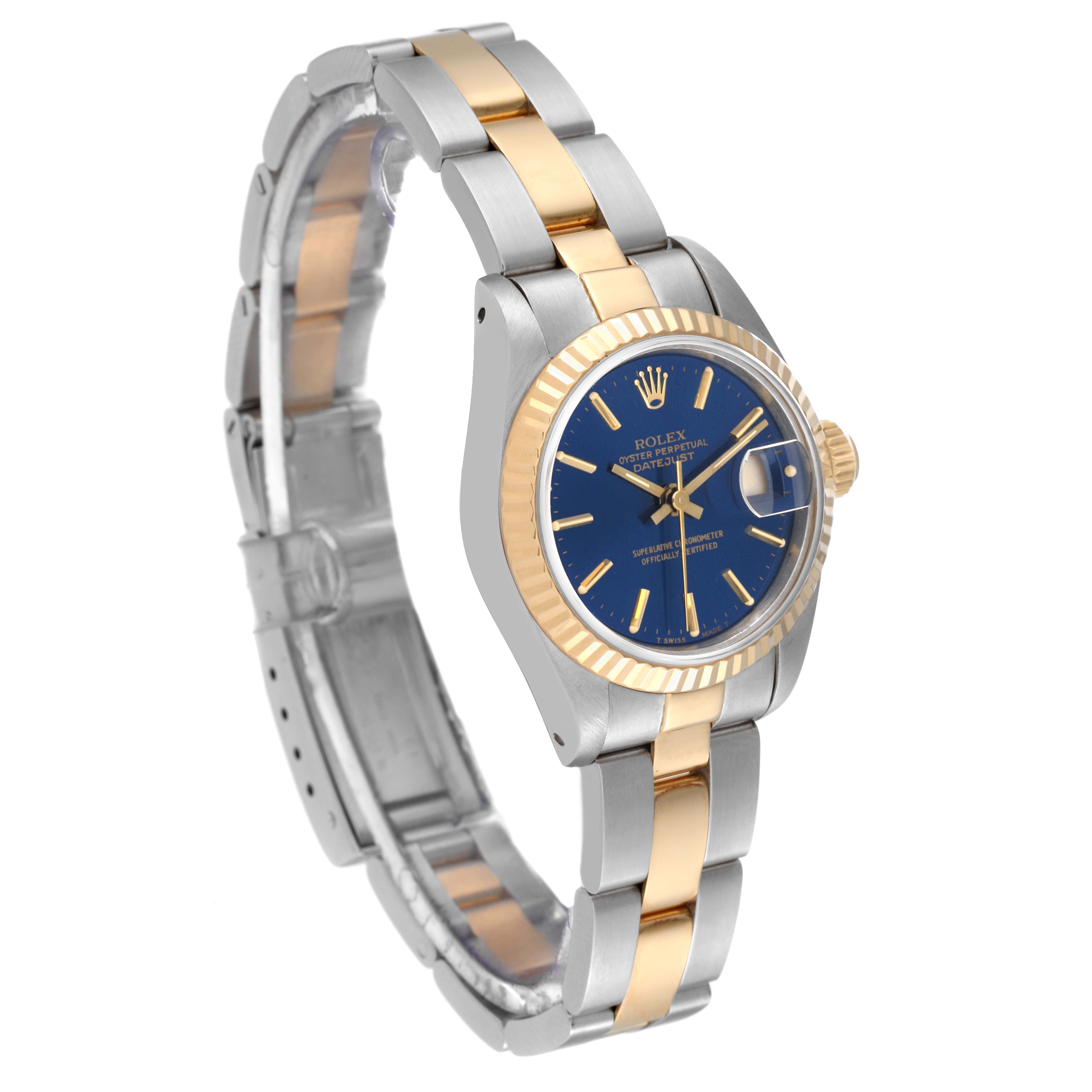 The image shows a side angle of a Rolex Datejust 69173 Women's Steel and Gold (two tone) Blue Dial 69173 Women's Steel and Gold (two tone) Blue Dial watch, highlighting its two-tone bracelet, fluted bezel, and blue dial.