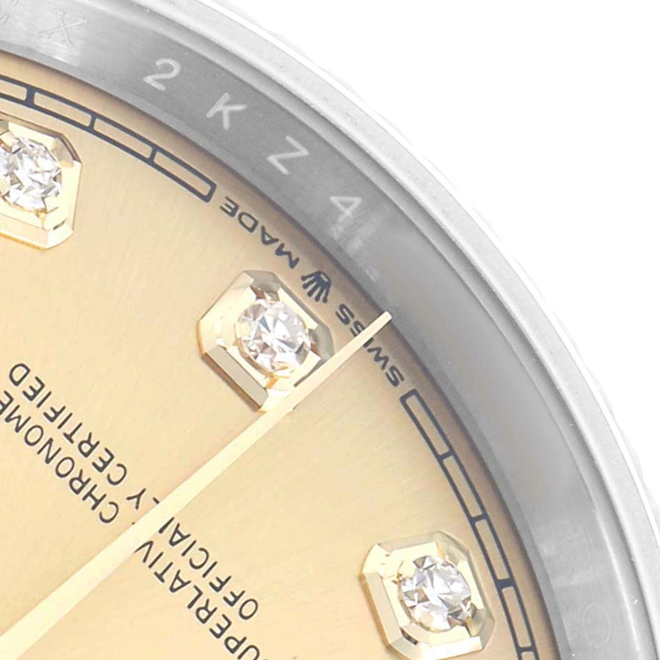 The image shows a close-up of the Rolex Datejust 126233 Men
s Steel and Gold (two tone) Champagne Dial watch face, highlighting the bezel, markers, and part of the dial with diamonds.