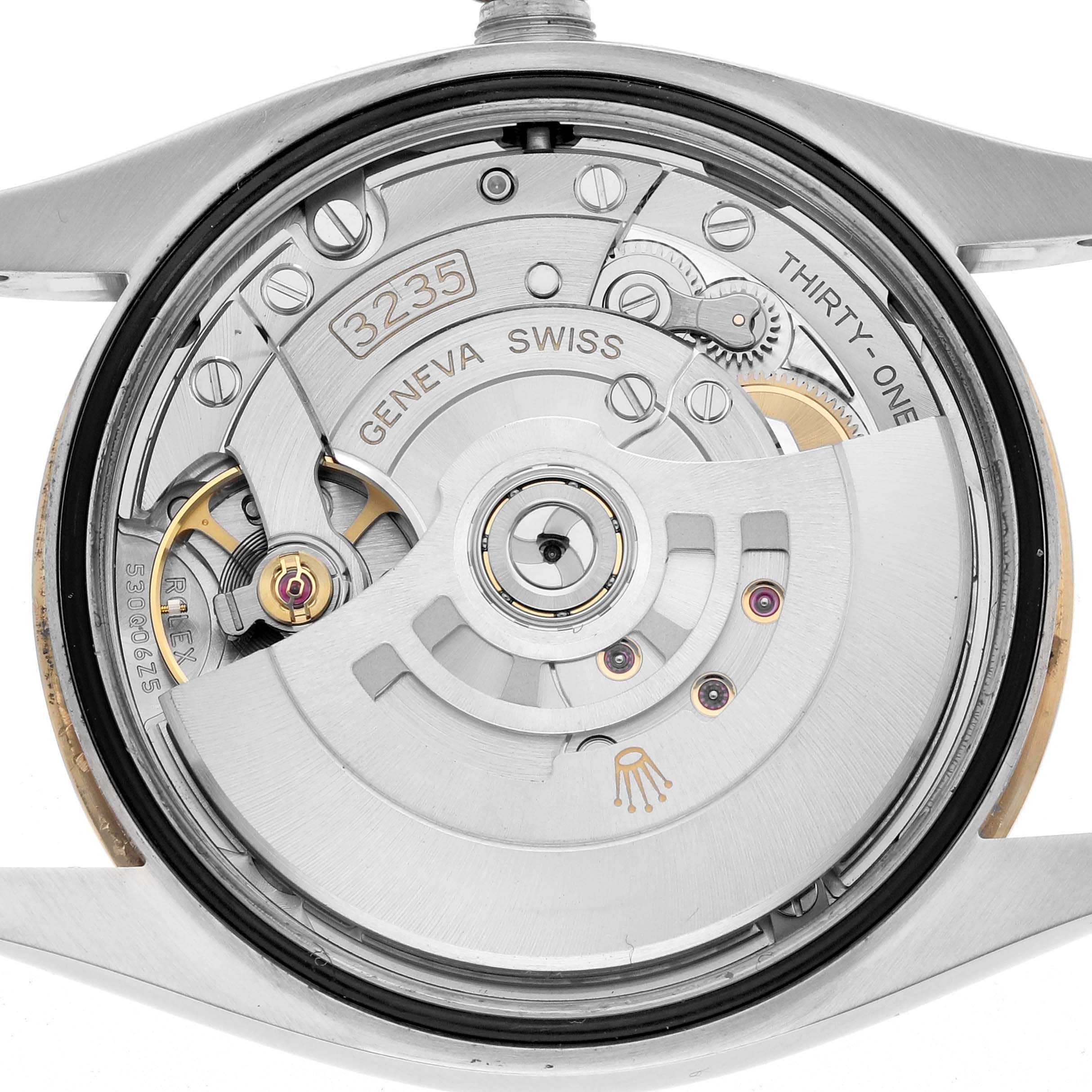 The image shows the Rolex Datejust 126233 Men
s Steel and Gold (two tone) Champagne Dial movement from the back, detailing the automatic rotor, gears, and engraving.