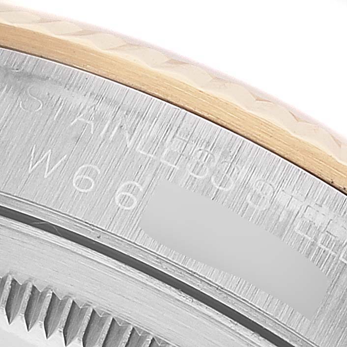 This close-up image shows part of the bezel and caseback of a Rolex Datejust 16233 Men's Steel and Gold (two tone) Champagne Dial 16233 Men's Steel and Gold (two tone) Champagne Dial watch.