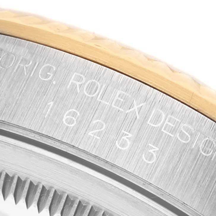 The image shows a close-up of the Rolex Datejust 16233 Men's Steel and Gold (two tone) Champagne Dial 16233 Men's Steel and Gold (two tone) Champagne Dial model's case, highlighting its reference number and fluted bezel.