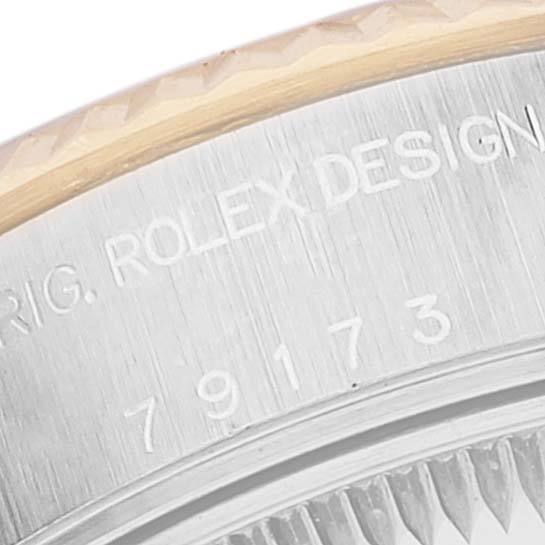 This image shows a close-up of the side casing with design details and model number of a Rolex Datejust 79173 Women's Steel and Gold (two tone) Silver Dial 79173 Women's Steel and Gold (two tone) Silver Dial watch.