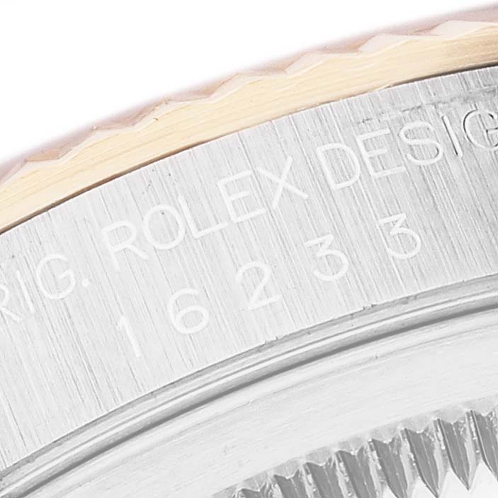 This image shows a close-up of the Rolex Datejust 16233 Men's Steel and Gold (two tone) White Dial 16233 Men's Steel and Gold (two tone) White Dial watch's model information engraved on the case.