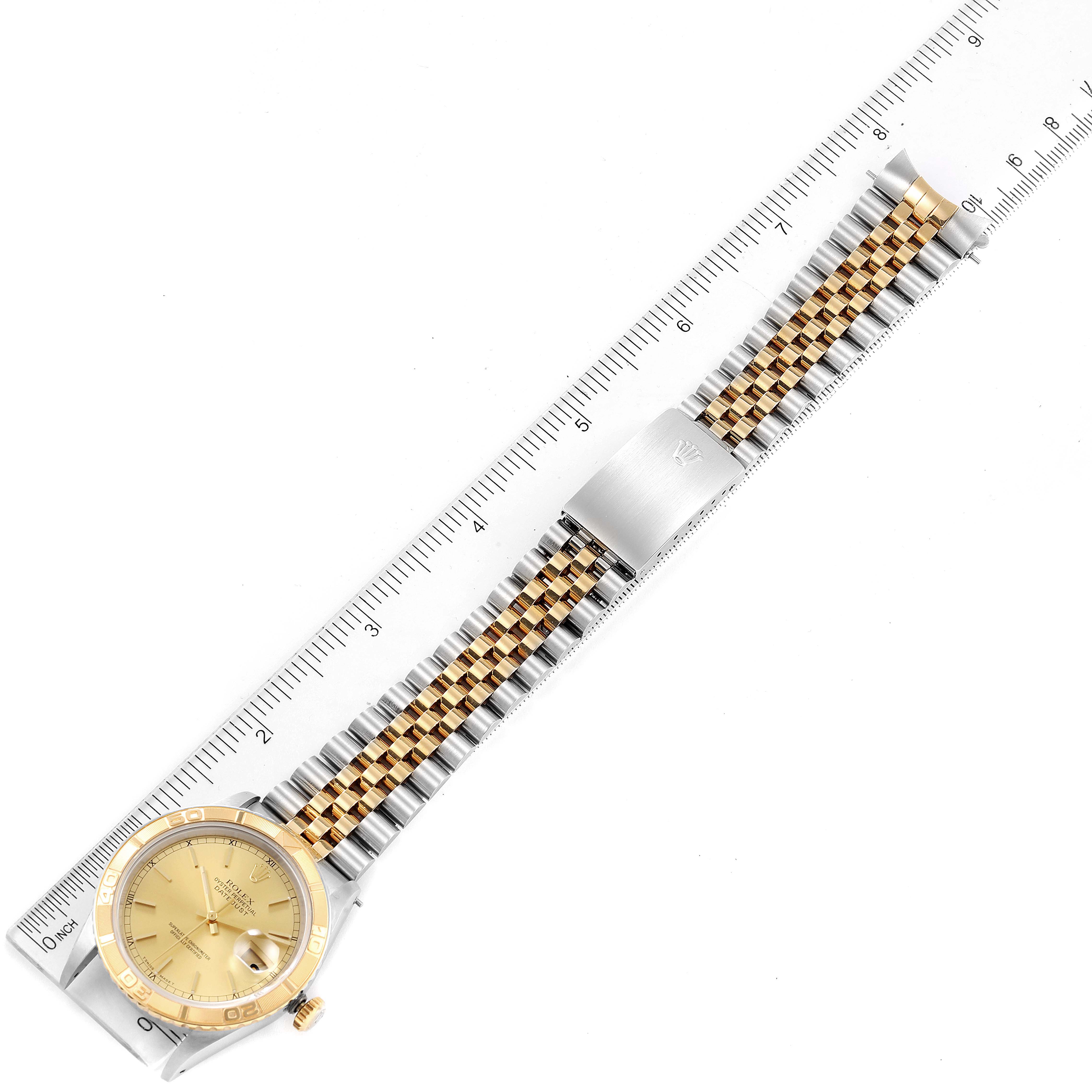This image shows a Rolex Turn-o-Graph 16263 Men's Steel and Gold (two tone) Champagne Dial 16263 Men's Steel and Gold (two tone) Champagne Dial watch horizontally aligned next to a ruler, displaying the full band and face.