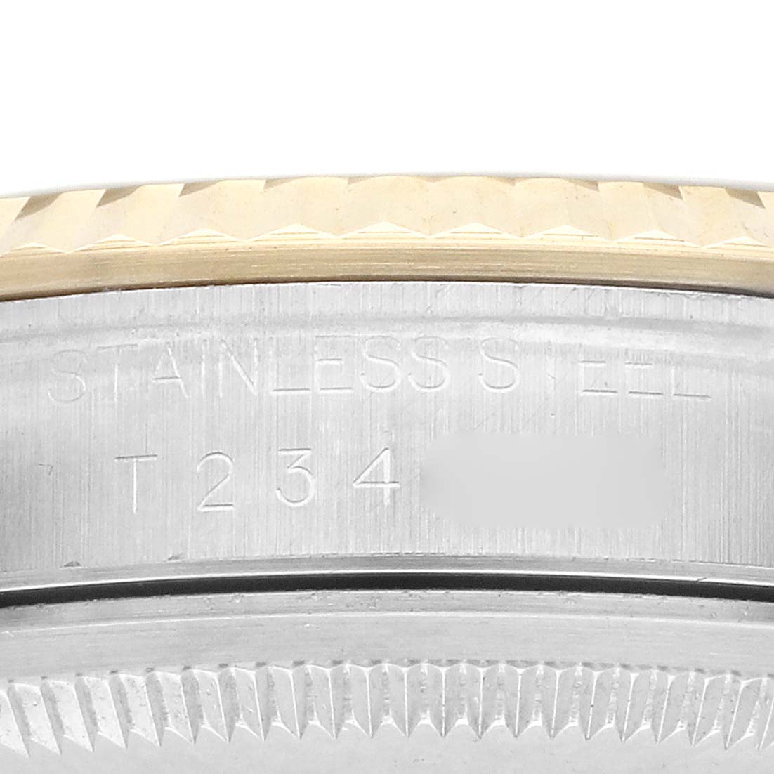 The image shows a close-up angle of the side of a Rolex Datejust 16233 Men
s Steel and Gold (two tone) Champagne Dial, focusing on the stainless steel casing and part of the bezel.